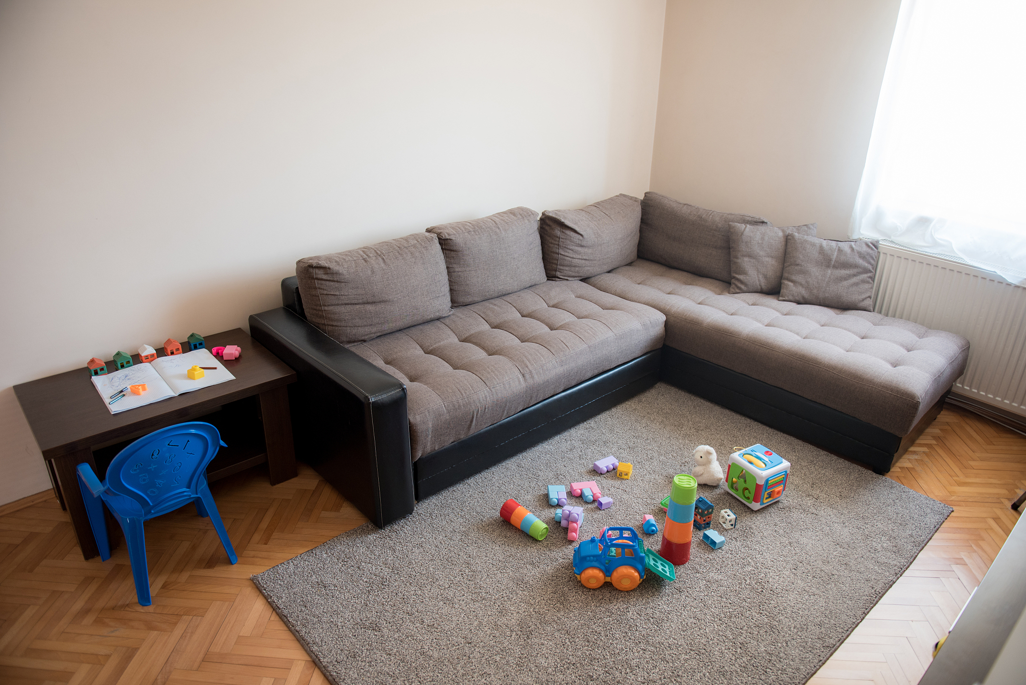 living room full of children toys left around after playing