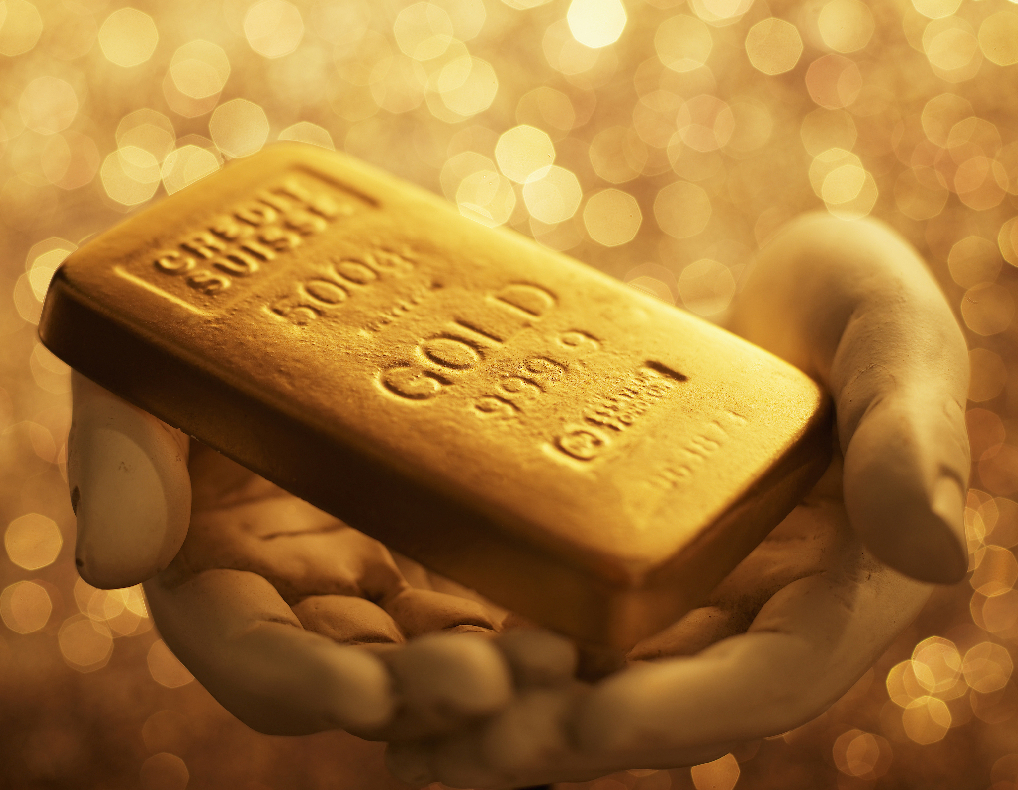 gold bar on hand sculpture