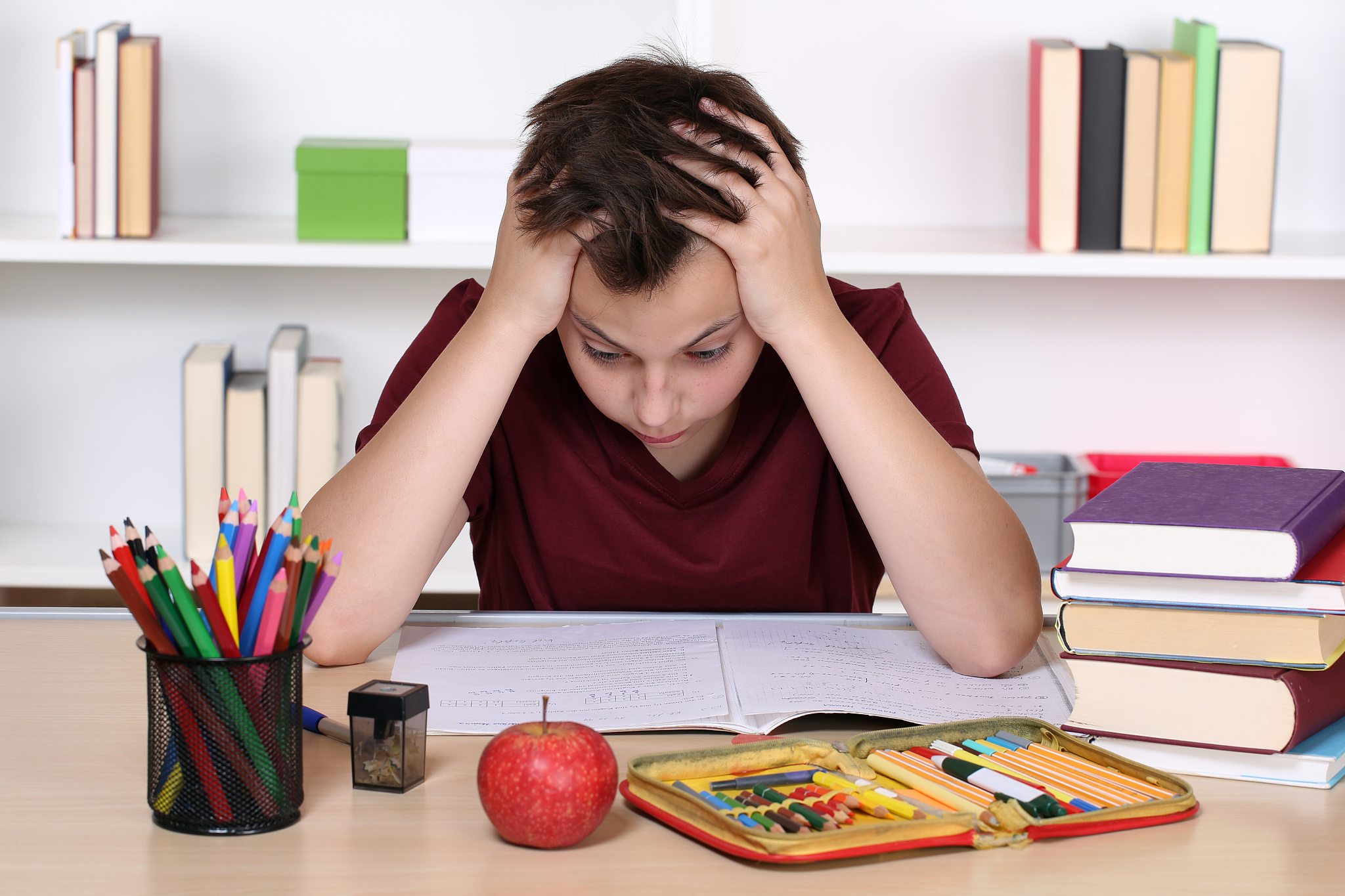 young student desperate while doing homework