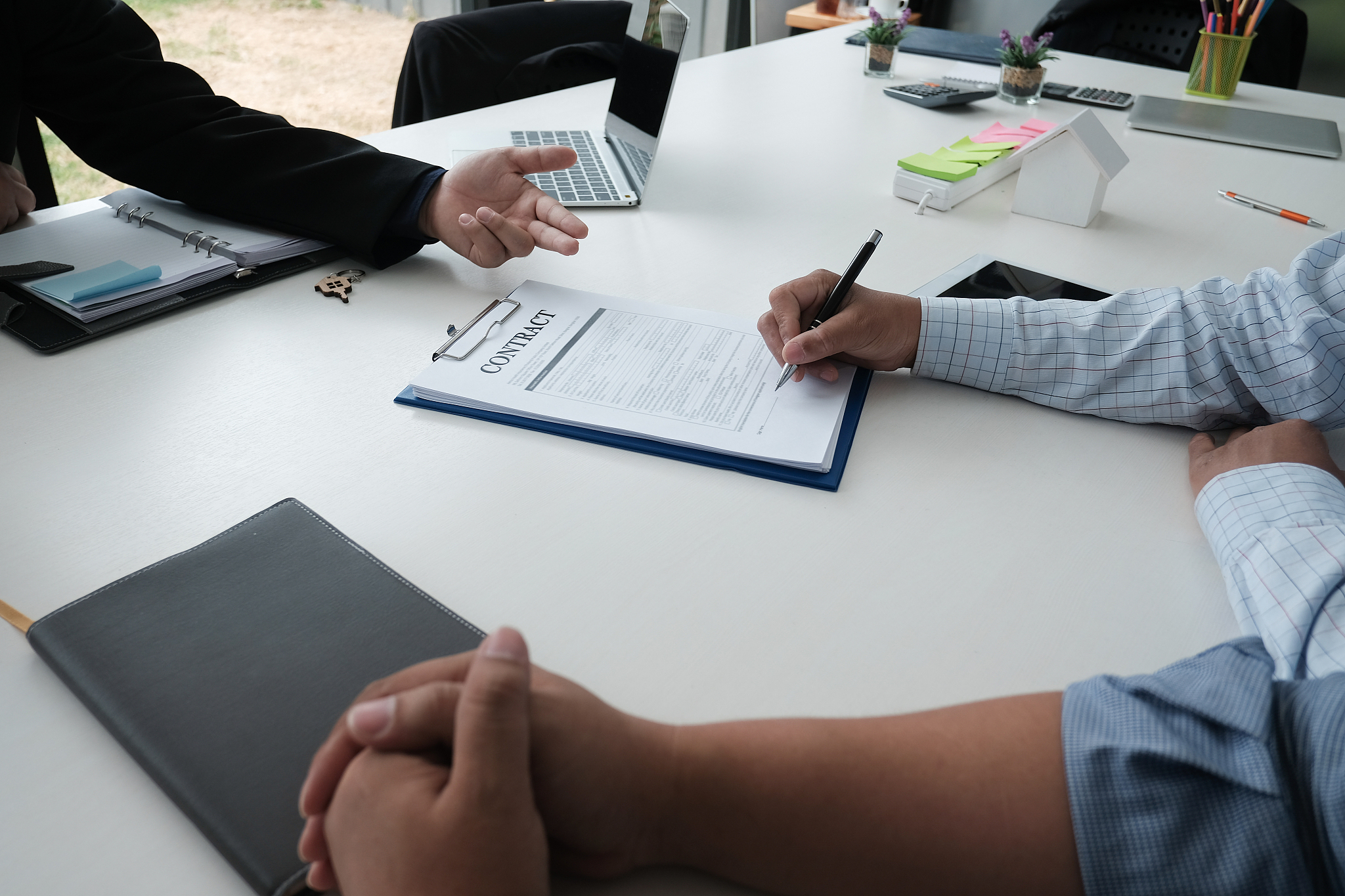 client signing contract with realtor at real estate agency. prop
