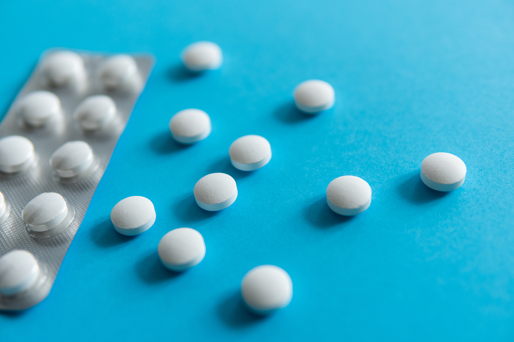 pills in the package. white pills on blue background. medicine, 