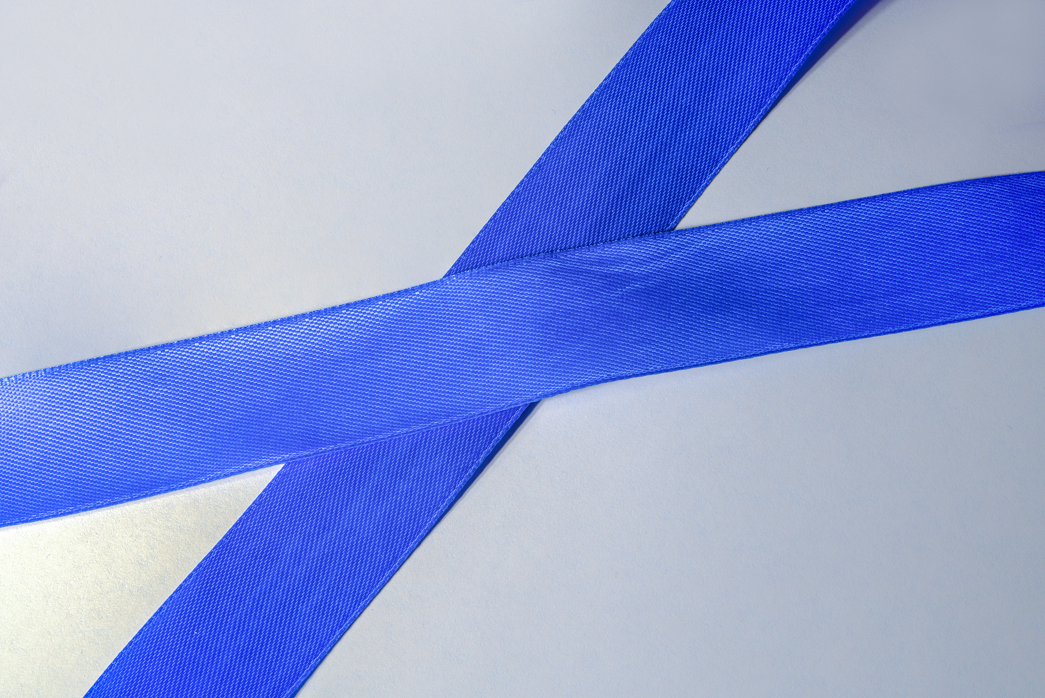blue ribbon on a white background  lies