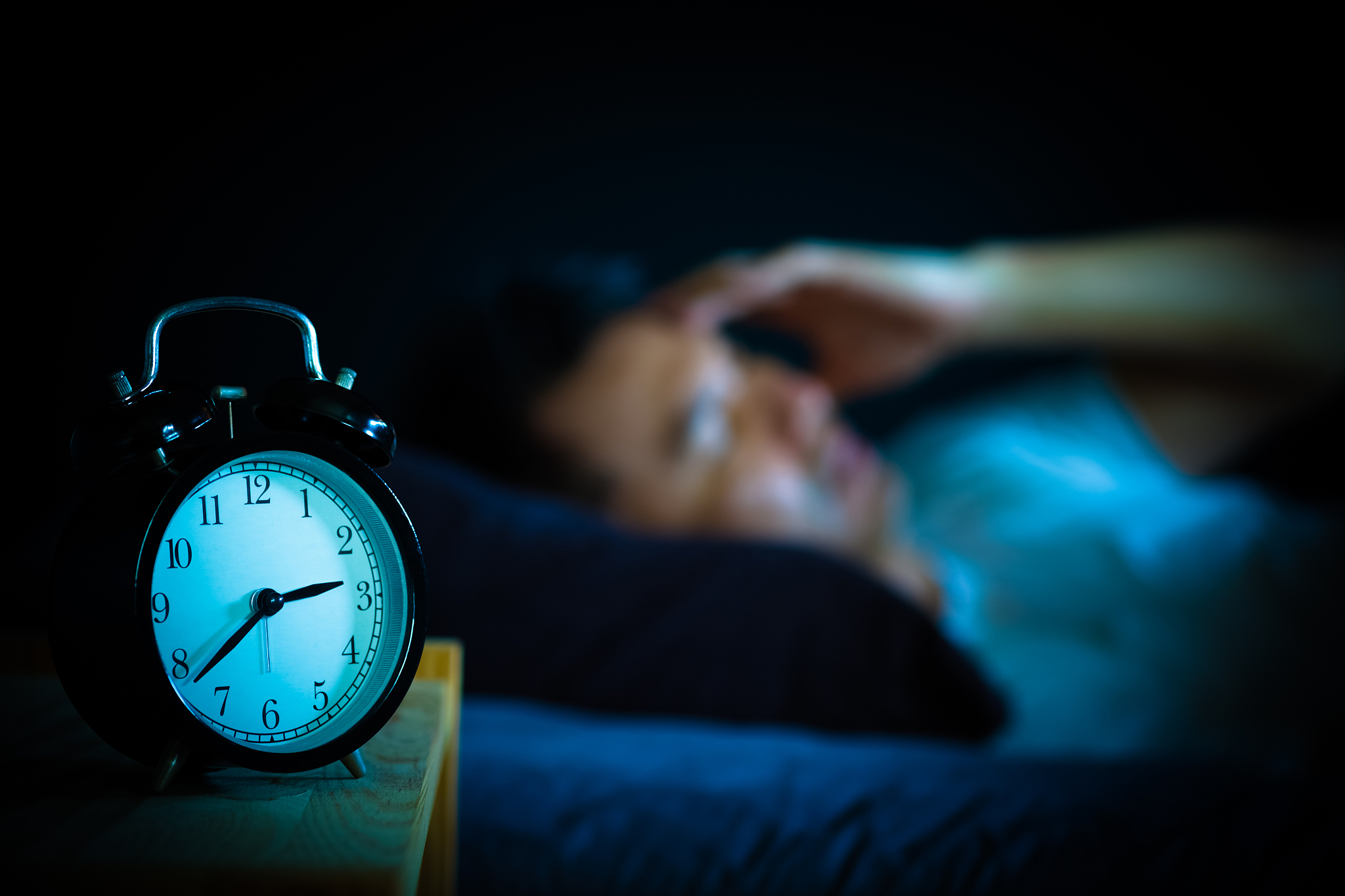 asian man in bed suffering insomnia and sleep disorder thinking 