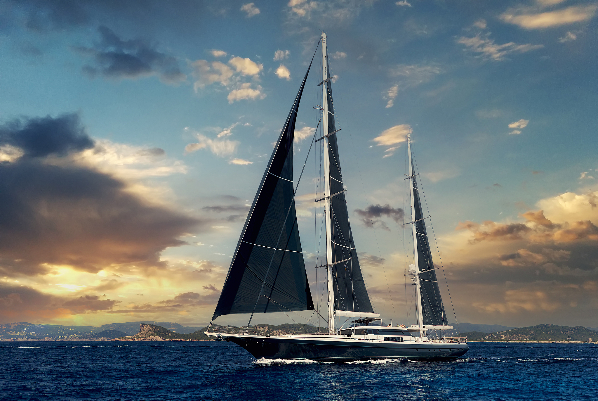 two-masted yacht in the mediterranean sea at sunset