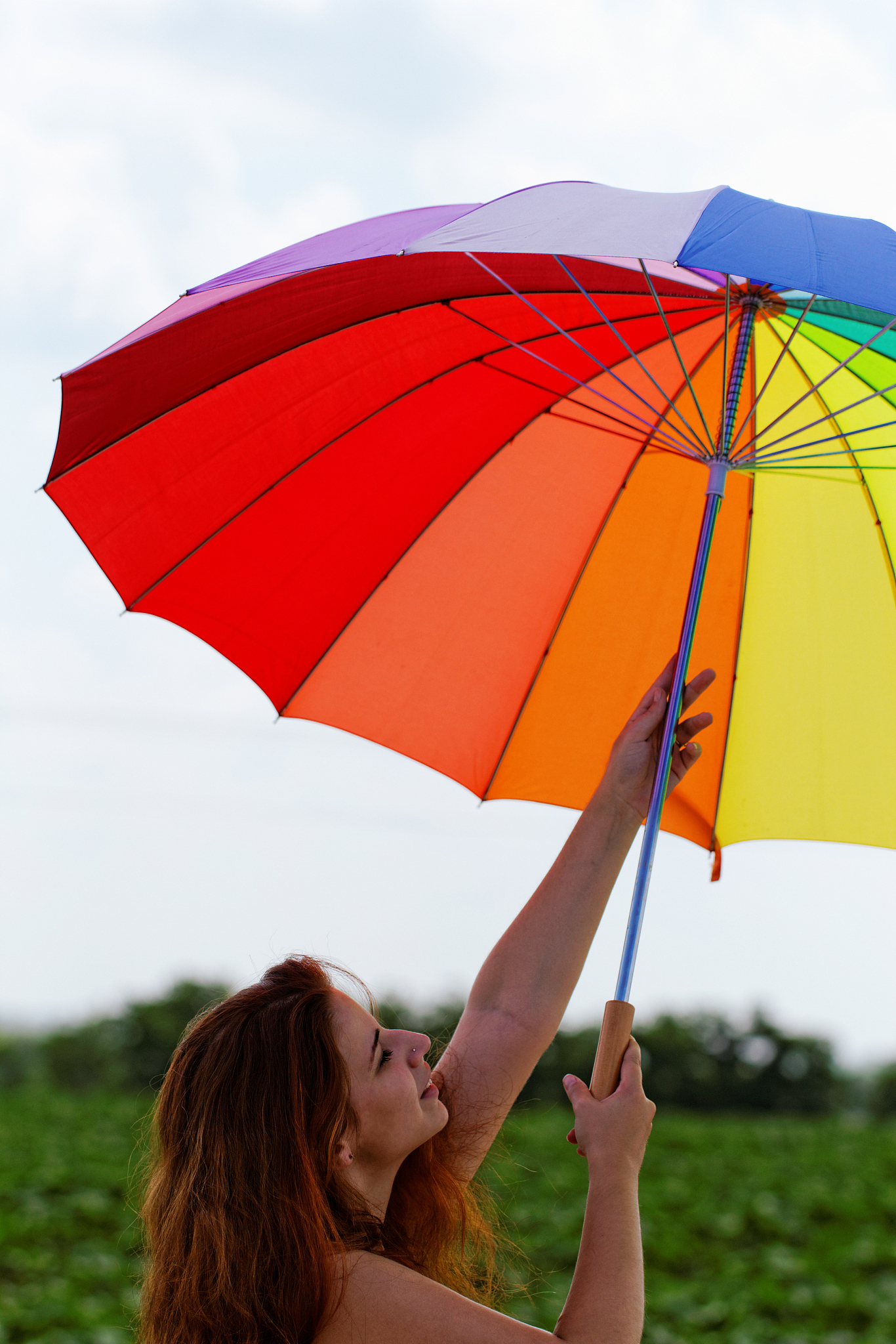 beautiful young girl with rainbow colored umbrella
