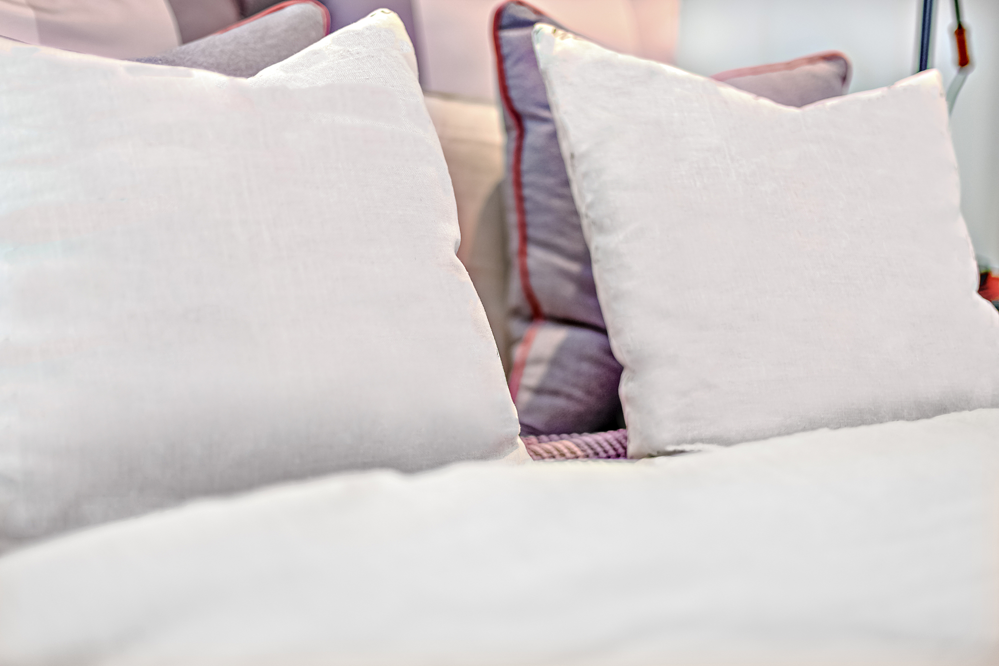 pillows with letter design on the bed close up