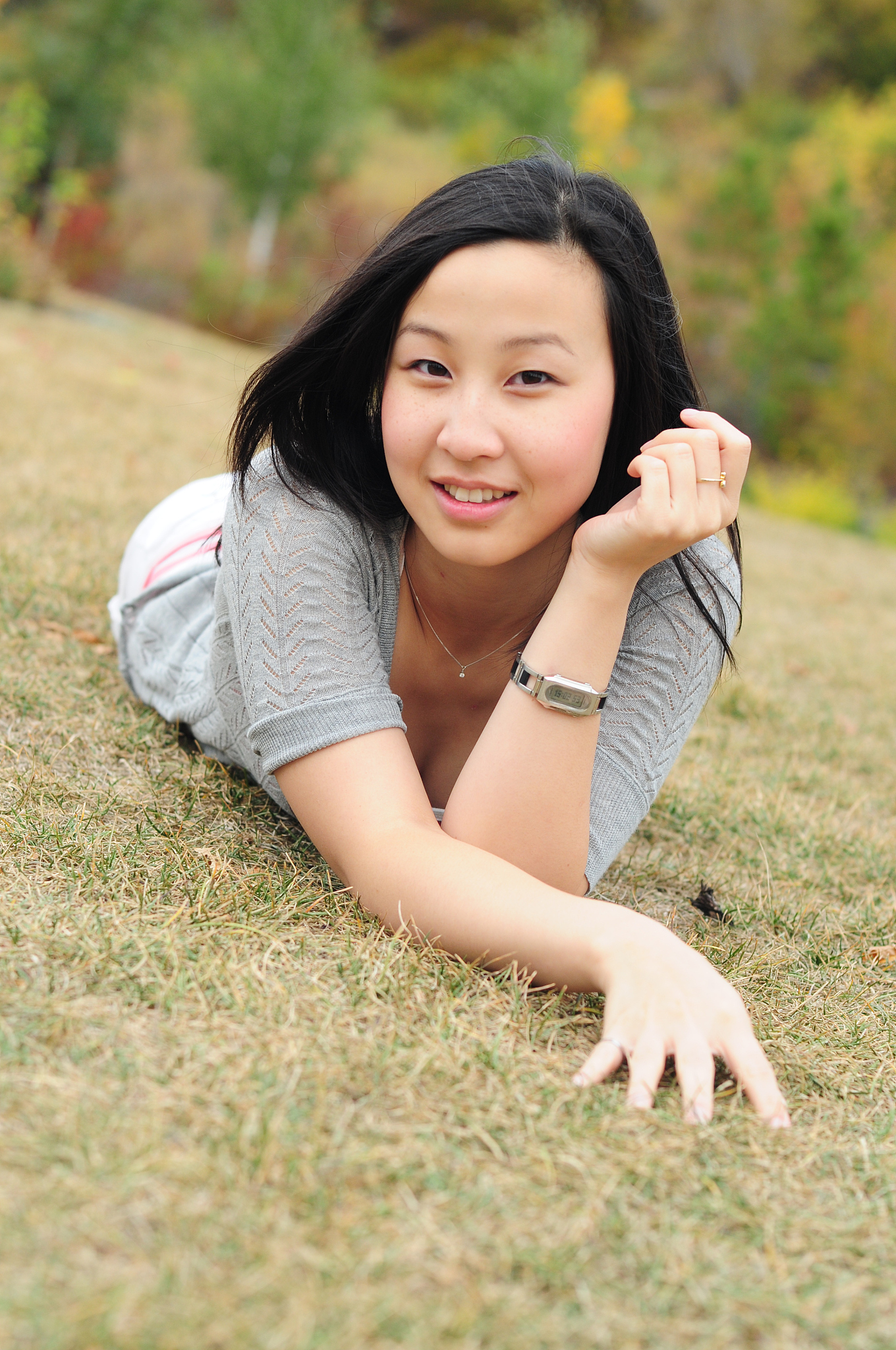 asian lady laying down on grass