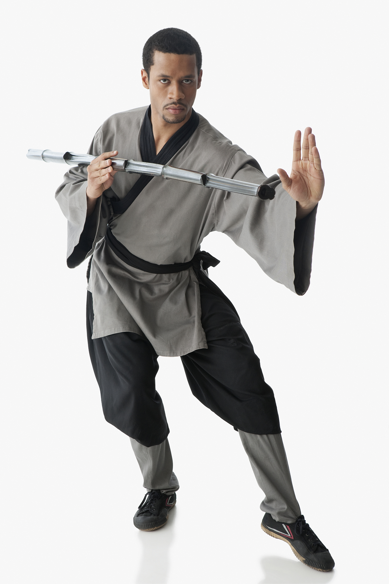 mixed race martial artist holding stick