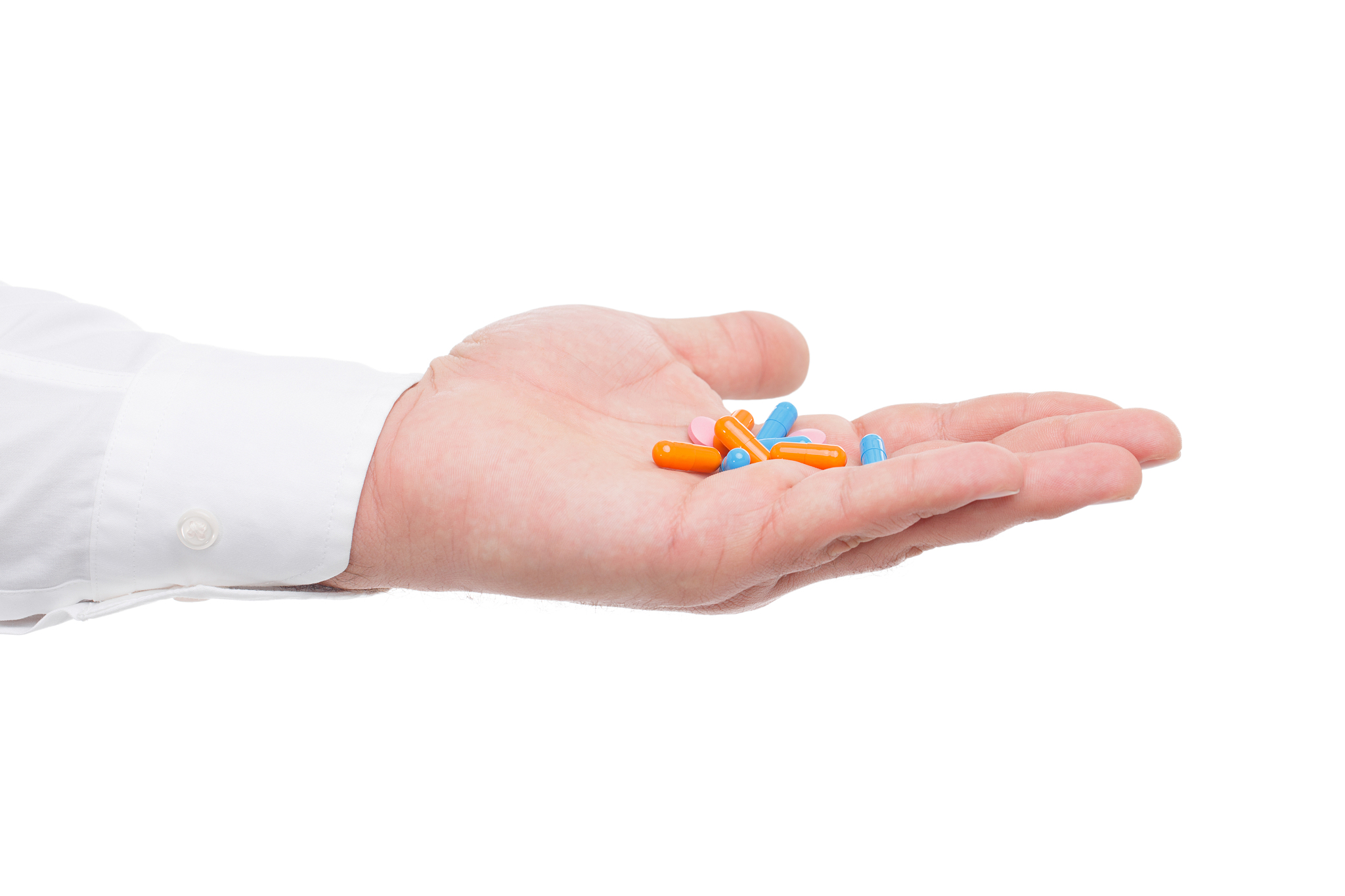 palm with pills close-up on white isolated background