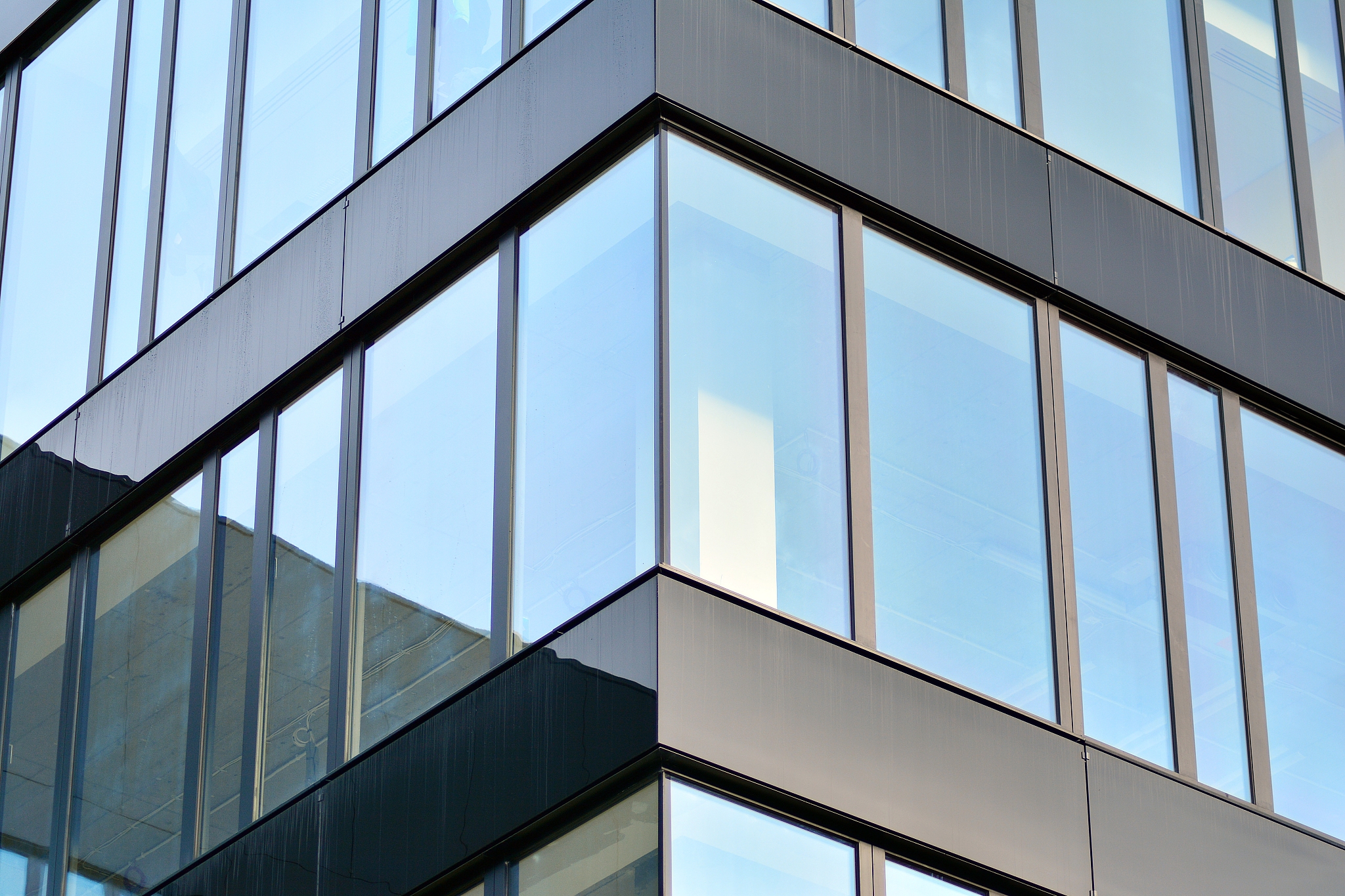 modern building with reflected sky and cloud in glass window