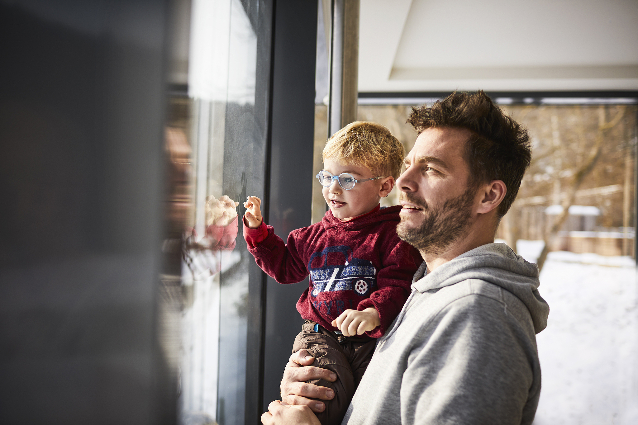 father and son looking out of the window