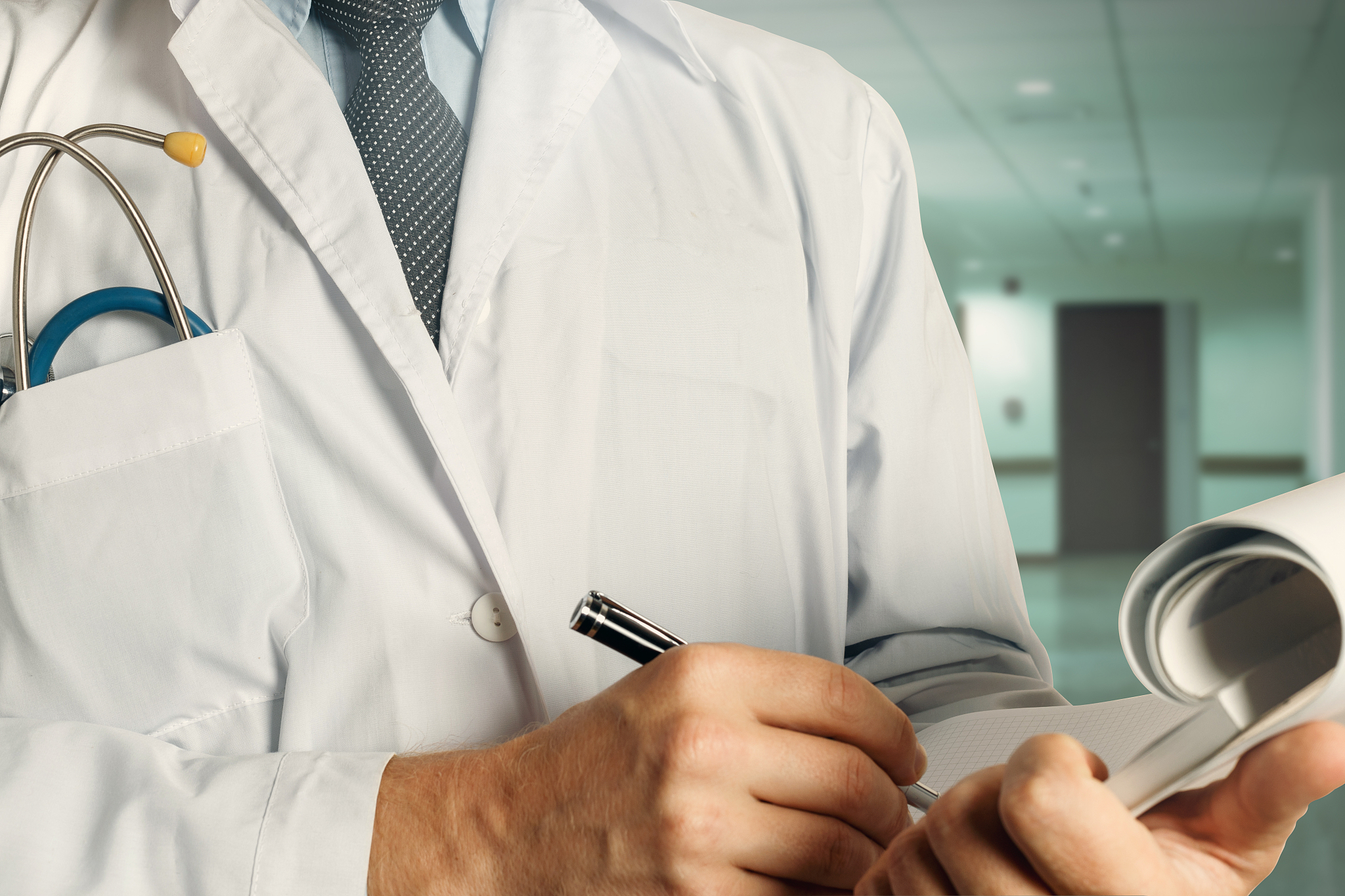healthcare and medicine. doctor writes data into medical history