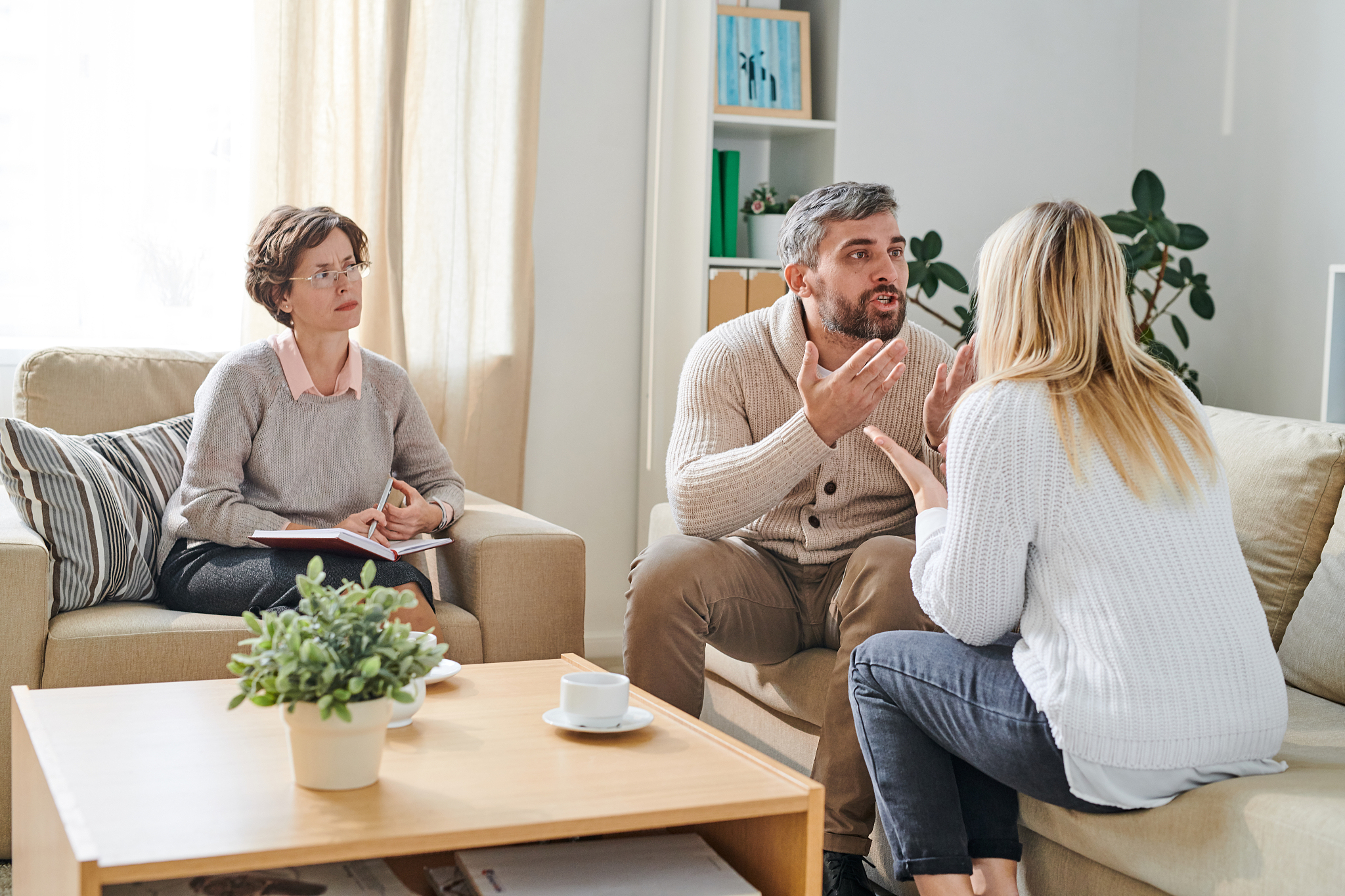 angry couple screaming at each other during psychological therap