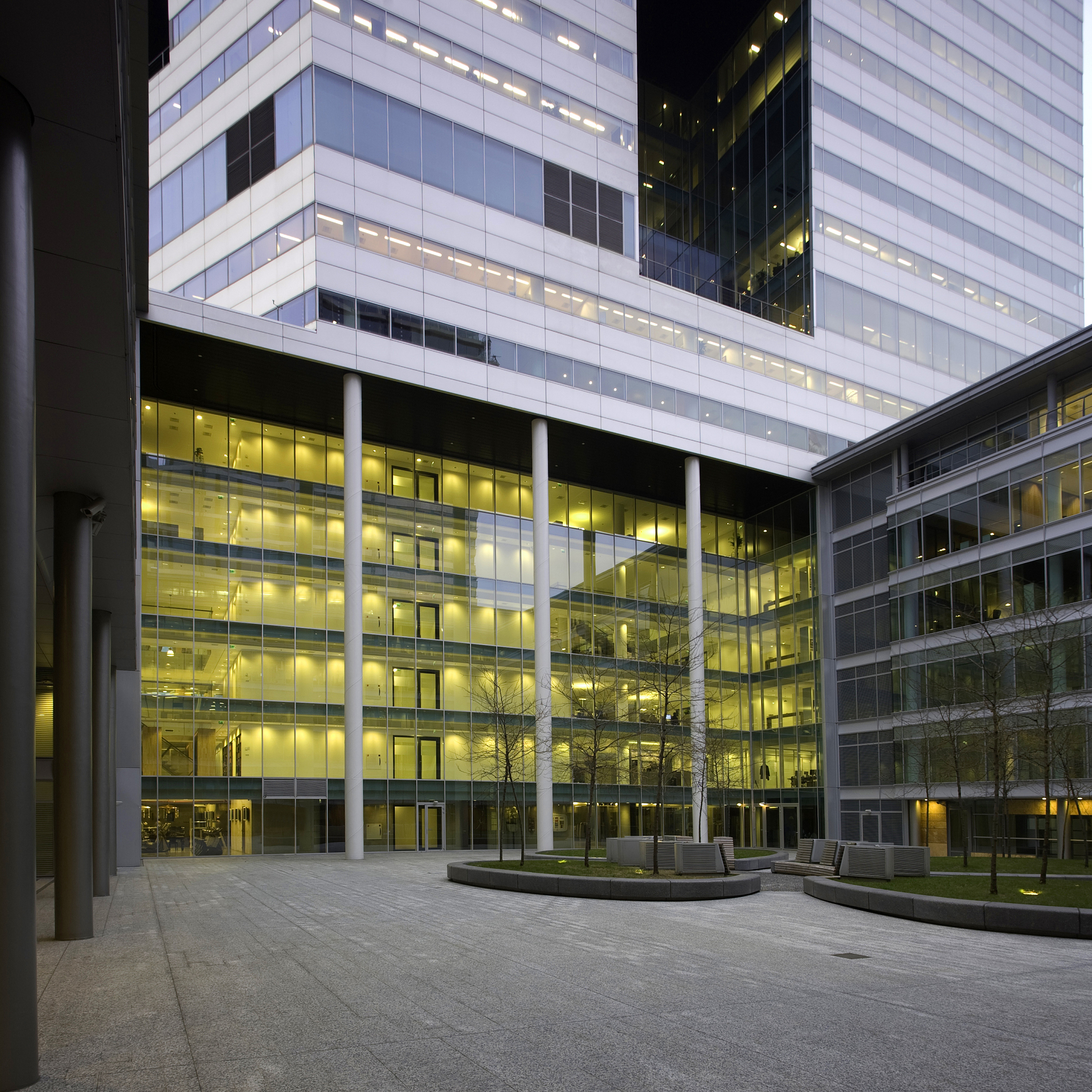 请修改成口语化的、单词简单的话：The man agrees with the professors opinion because he believes that spending money on an additional lighting system is a waste when there are more important projects that need funding