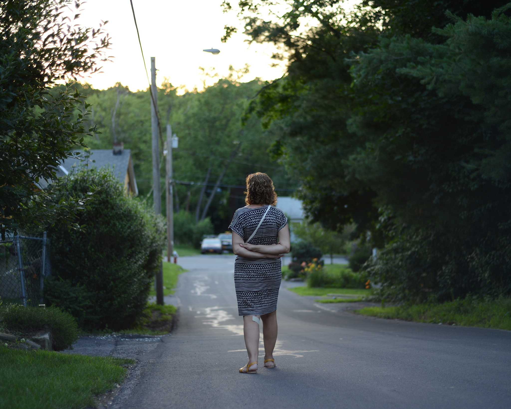 rear view of woman walking on country road