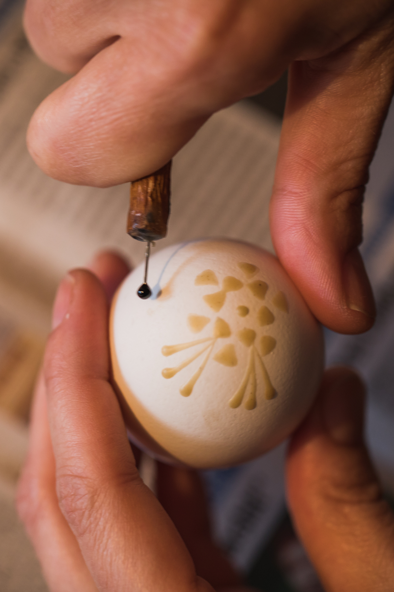 detailed macro shot of woman, handpainting an easter egg with wa