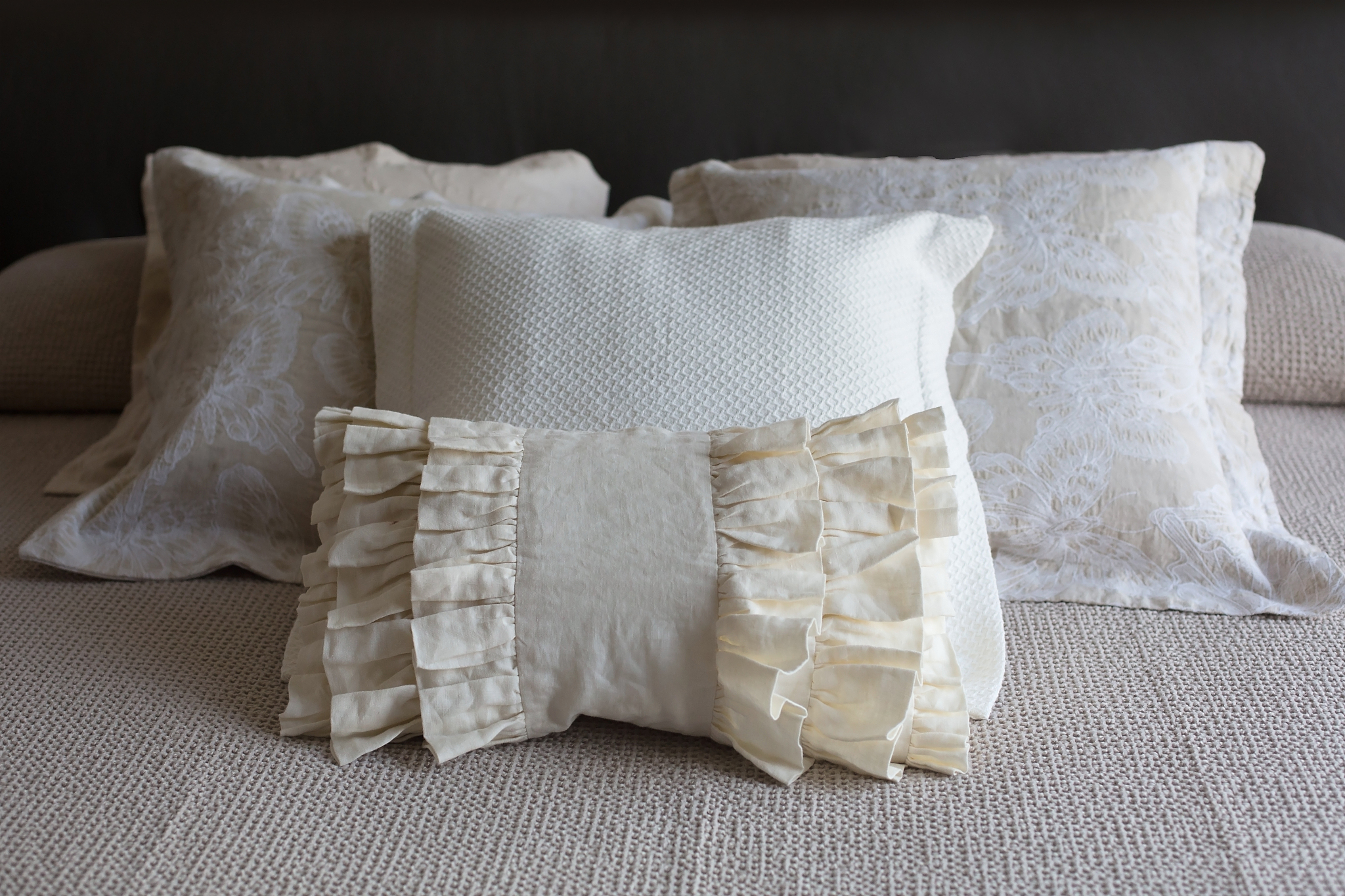 four beige natural fabric, linen cotton luxury lace pillows on b