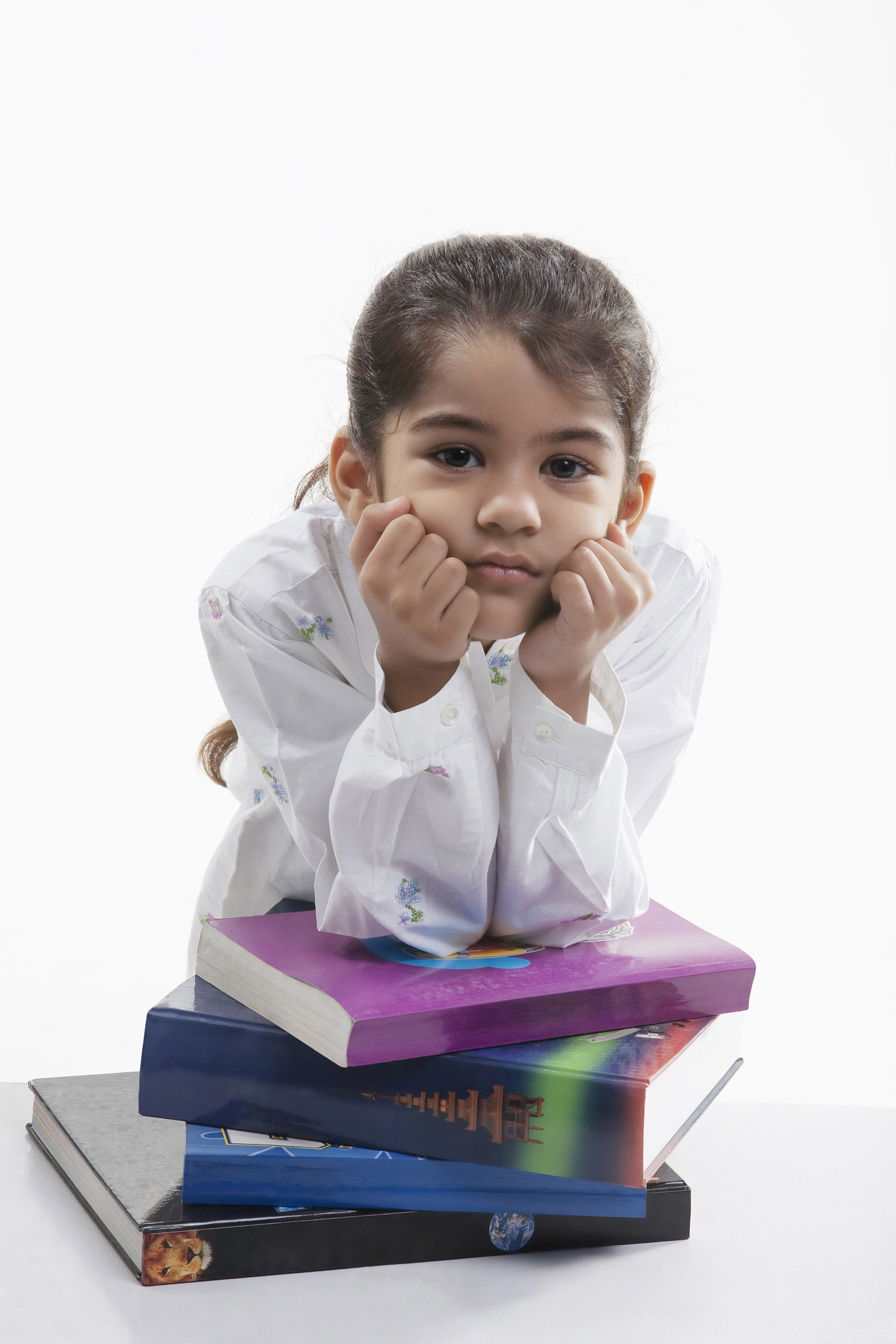 girl leaning on a stack of books