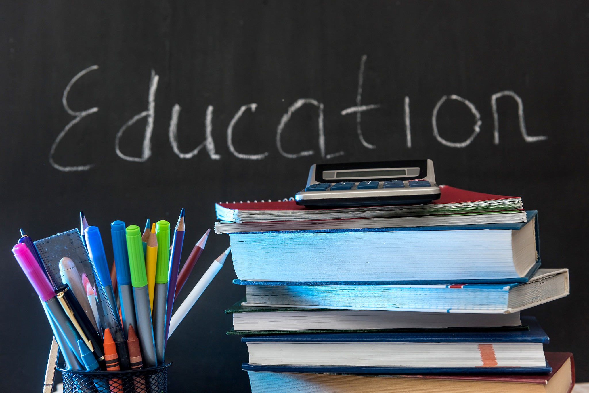 education word on chalkboard with school books on desk, educatio