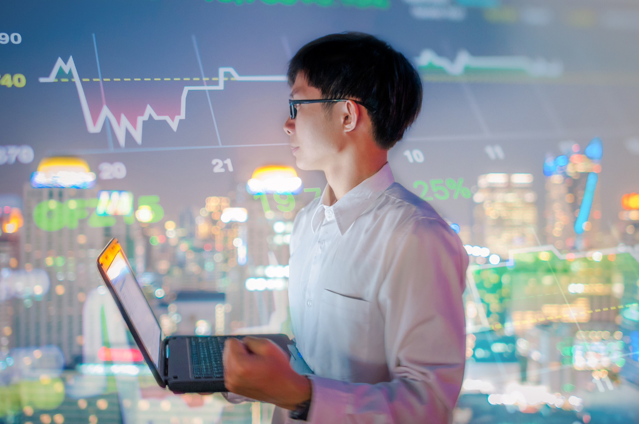 asian businessman using a laptop and smart phone analysis stock