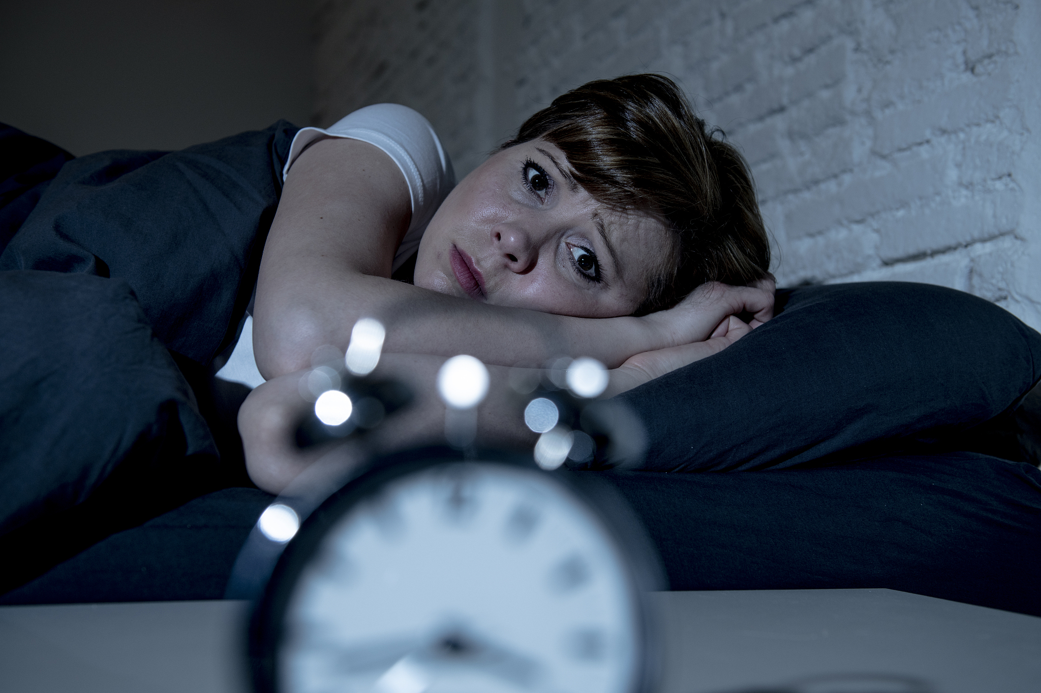 young attractive red haired caucasian woman lying in bed late at