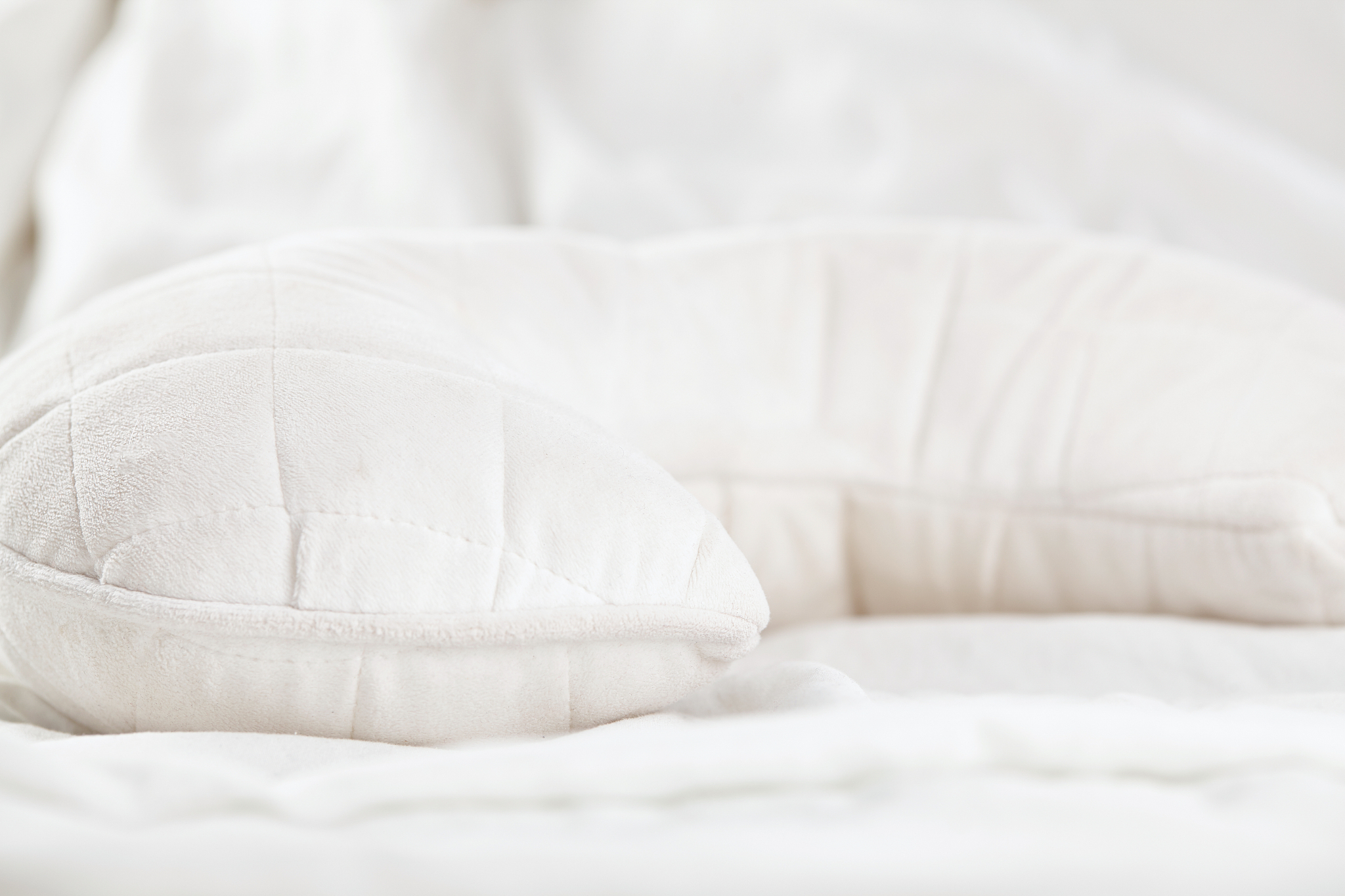 white ergonomic pillow in bed. close up.