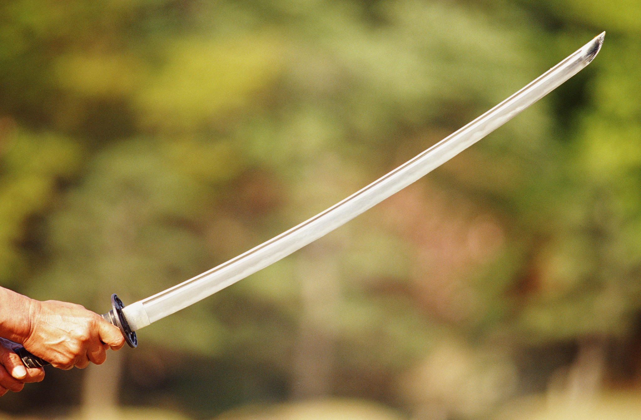 man holding samurai sword, close-up