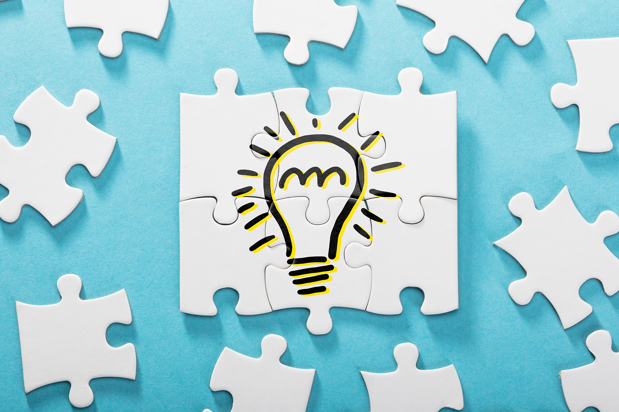 light bulb icon on white puzzle