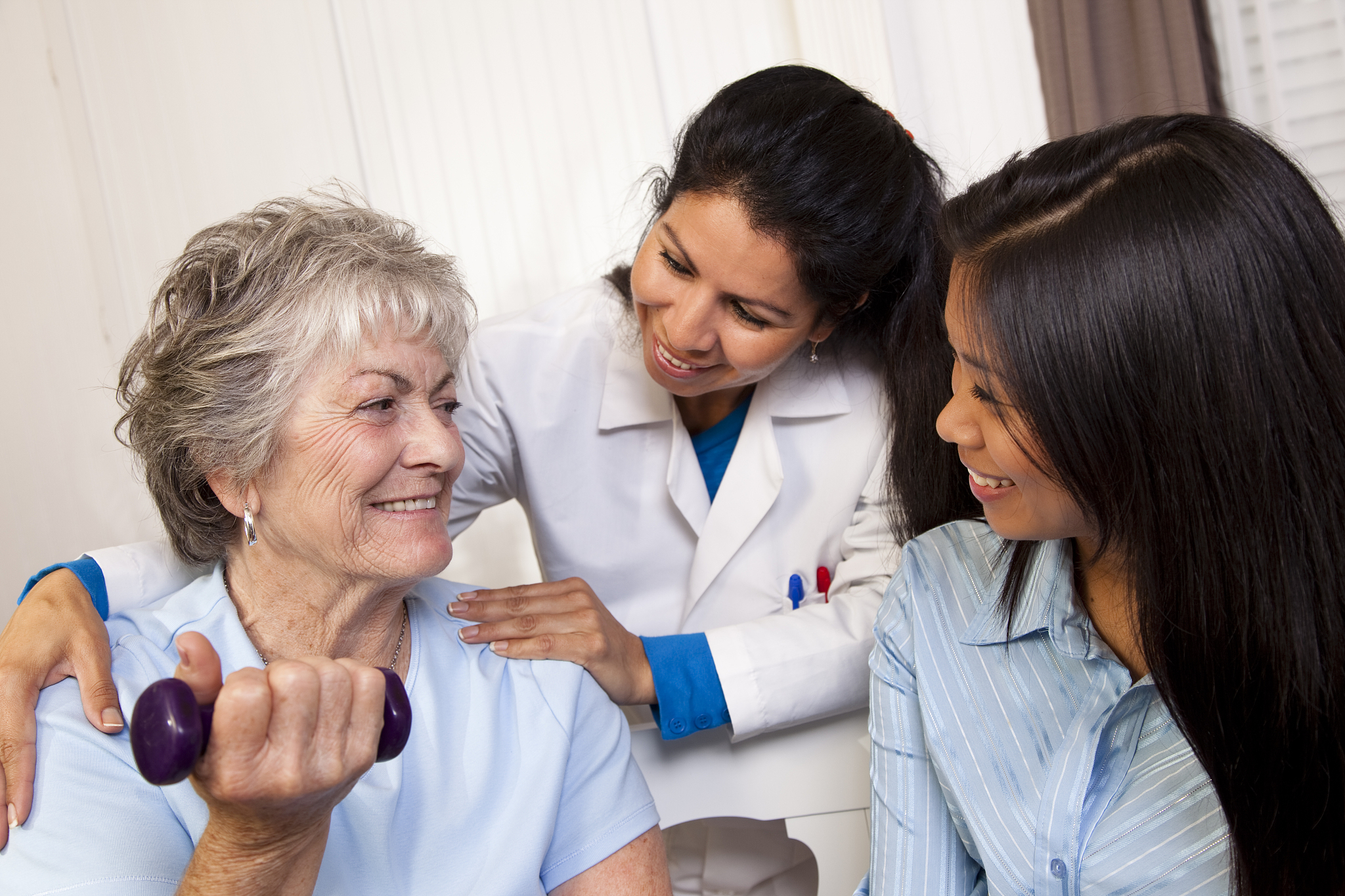 senior woman receiving home visit from nurse. physical therapy. 