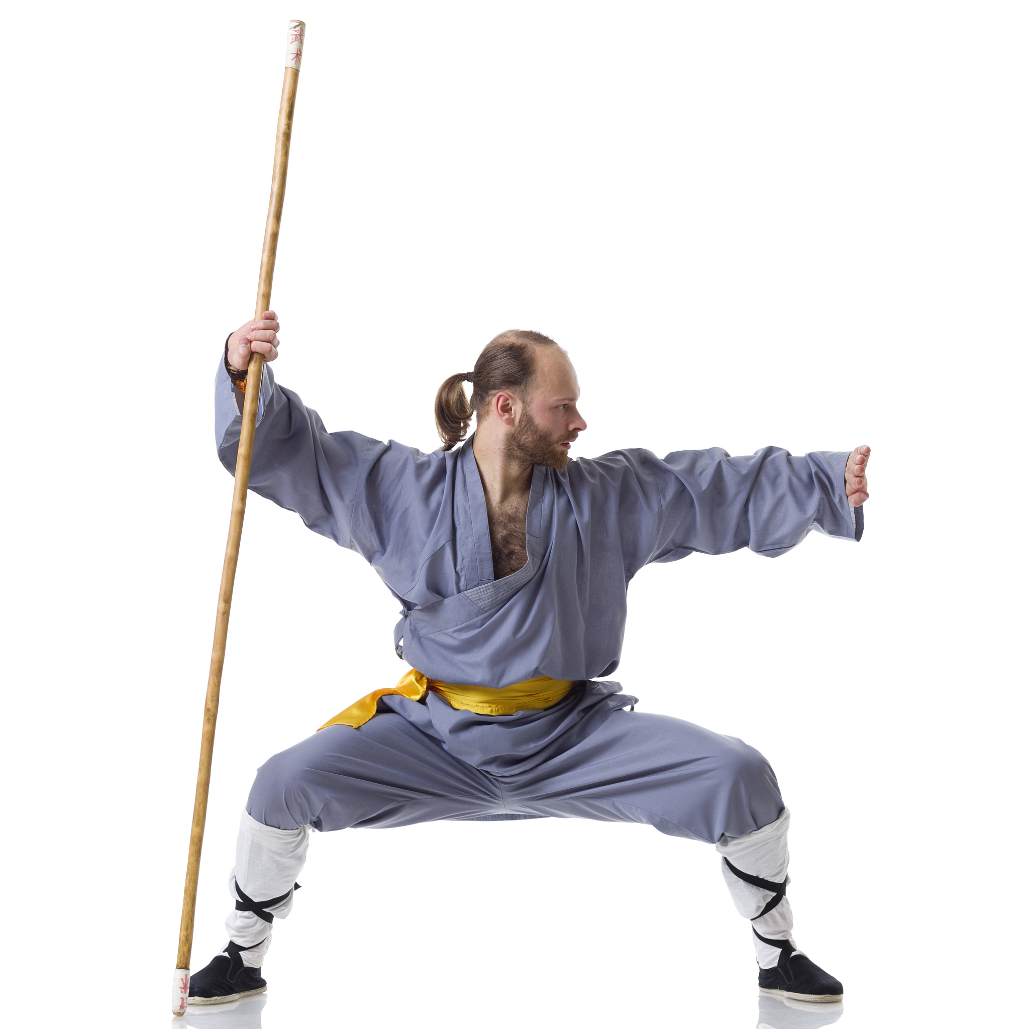 kung fu fighting position with wushu cudgel isolated on white
