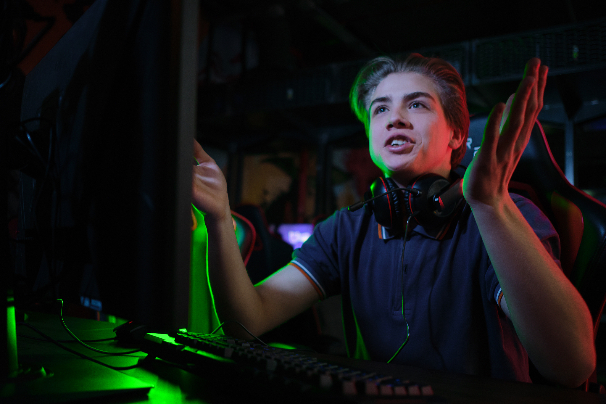 professional young caucasian gamer playing online on his pc. he 