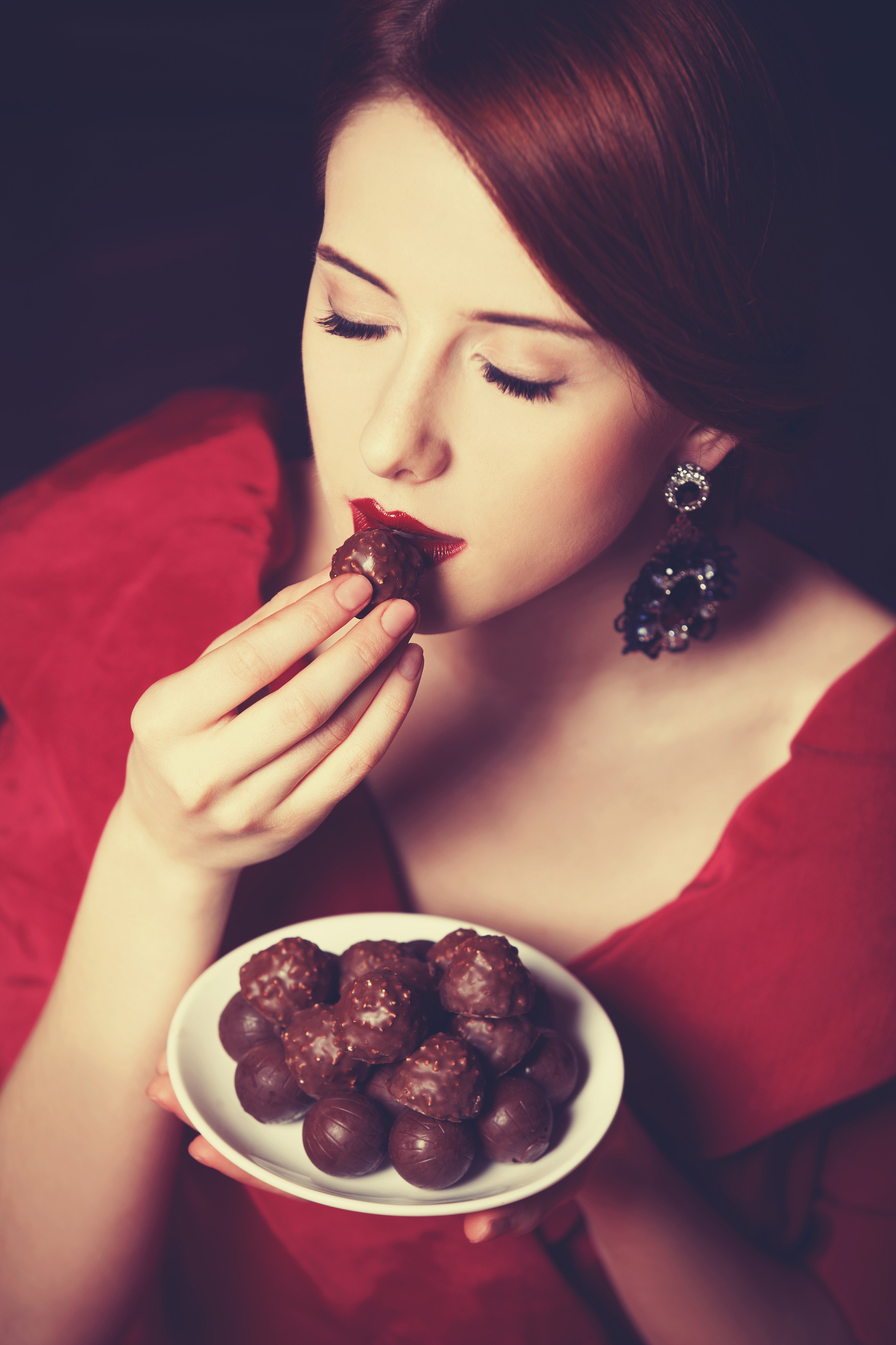 beautiful redhead women with candy.