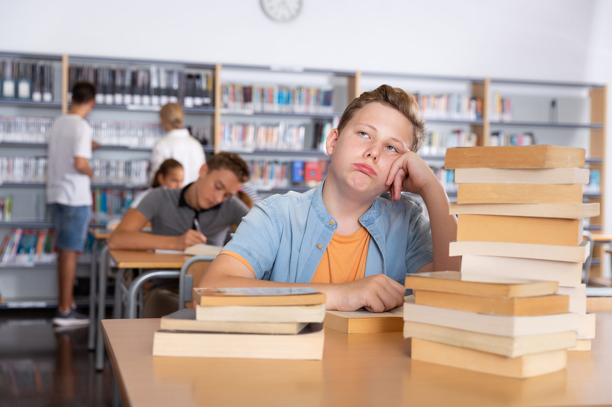 bored schoolboy in college library