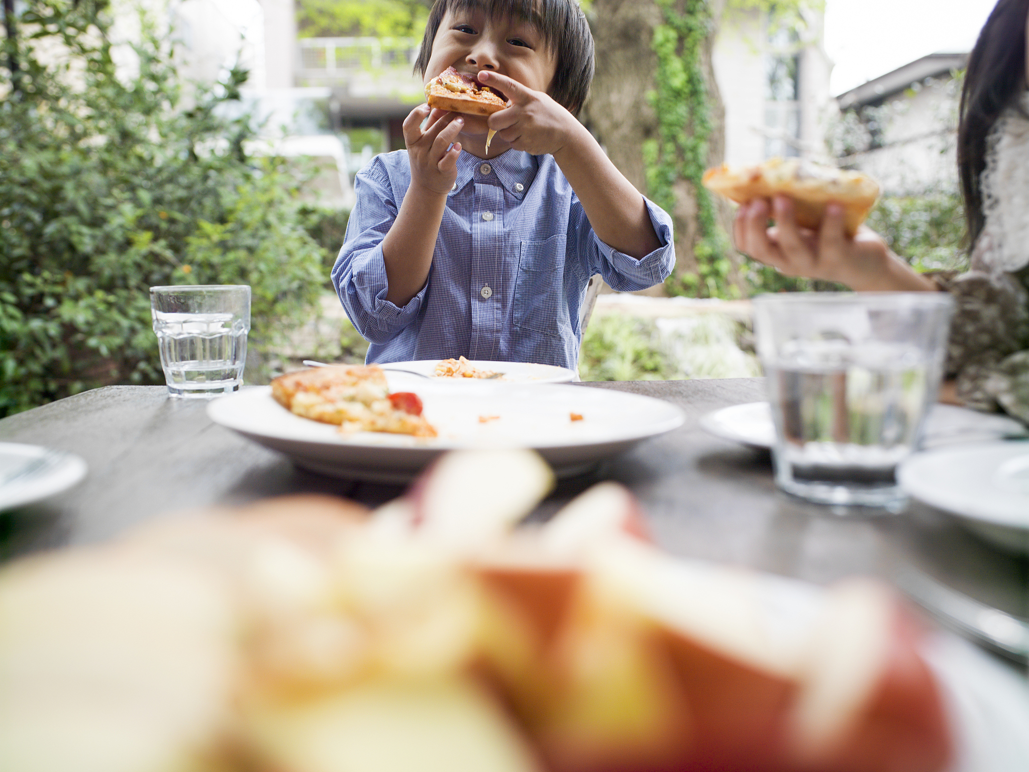 little boy  eating slices of pizza