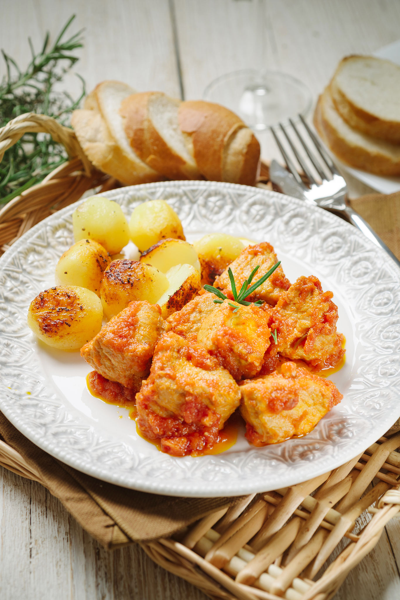 meat stew with baked potatoes on white plate