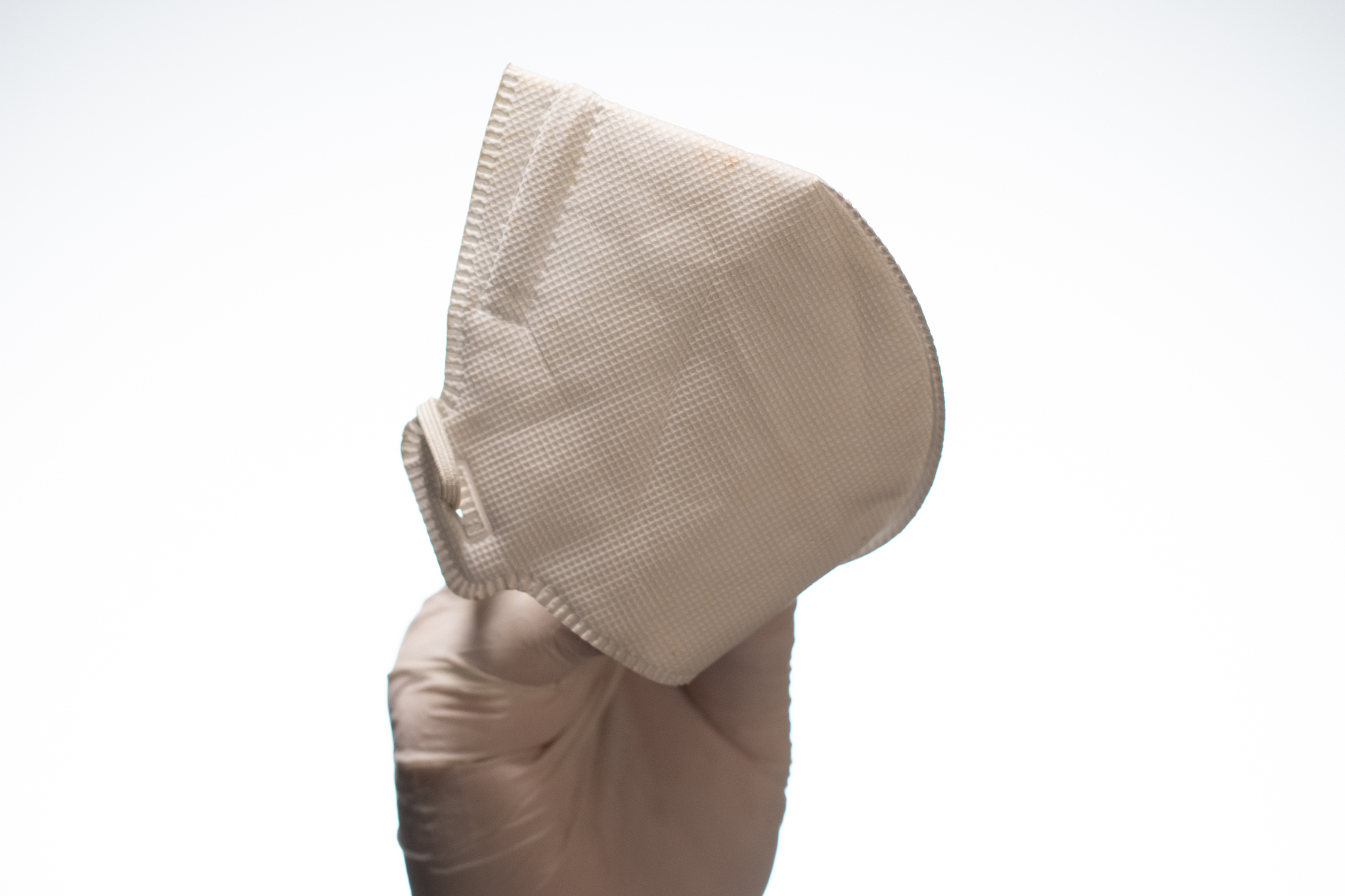 hand holding medical mask on white background