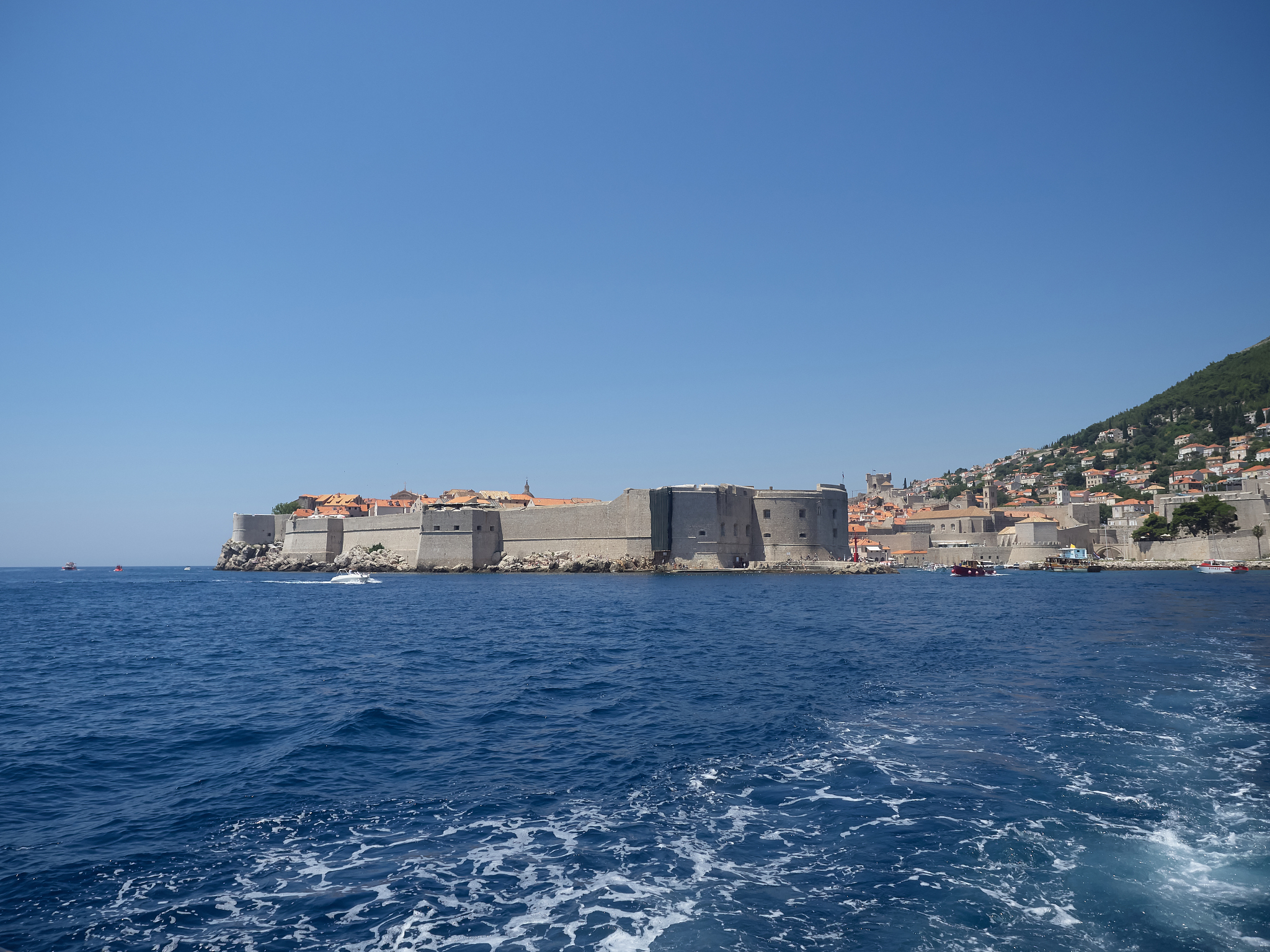 view of dubrovnik old town during a boat tour in a sunny summer 