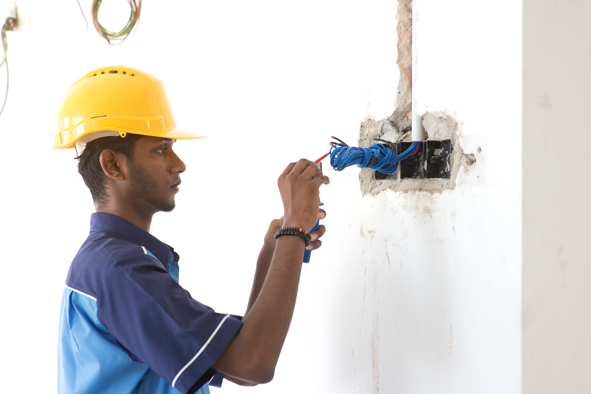young man working while standing by wall