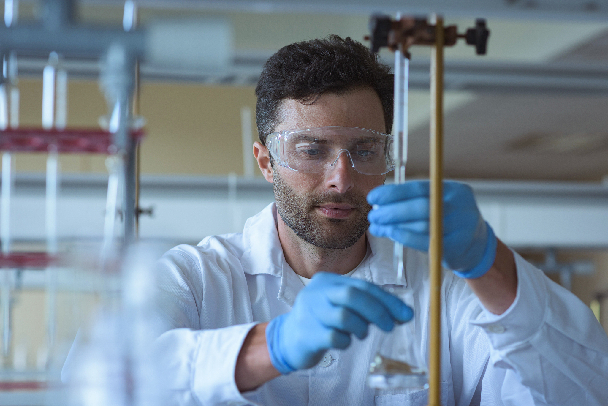 university student doing a chemical experiment in laboratory