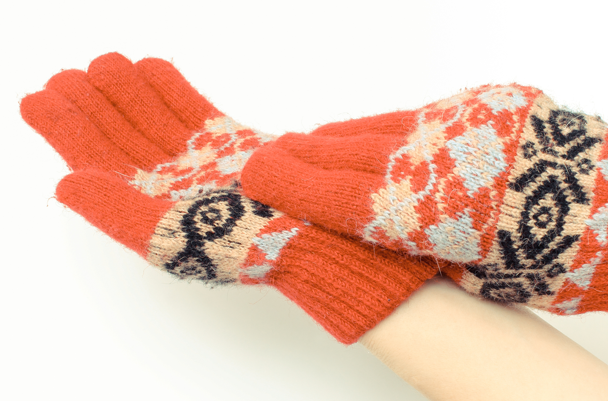 hands of woman putting on woolen gloves