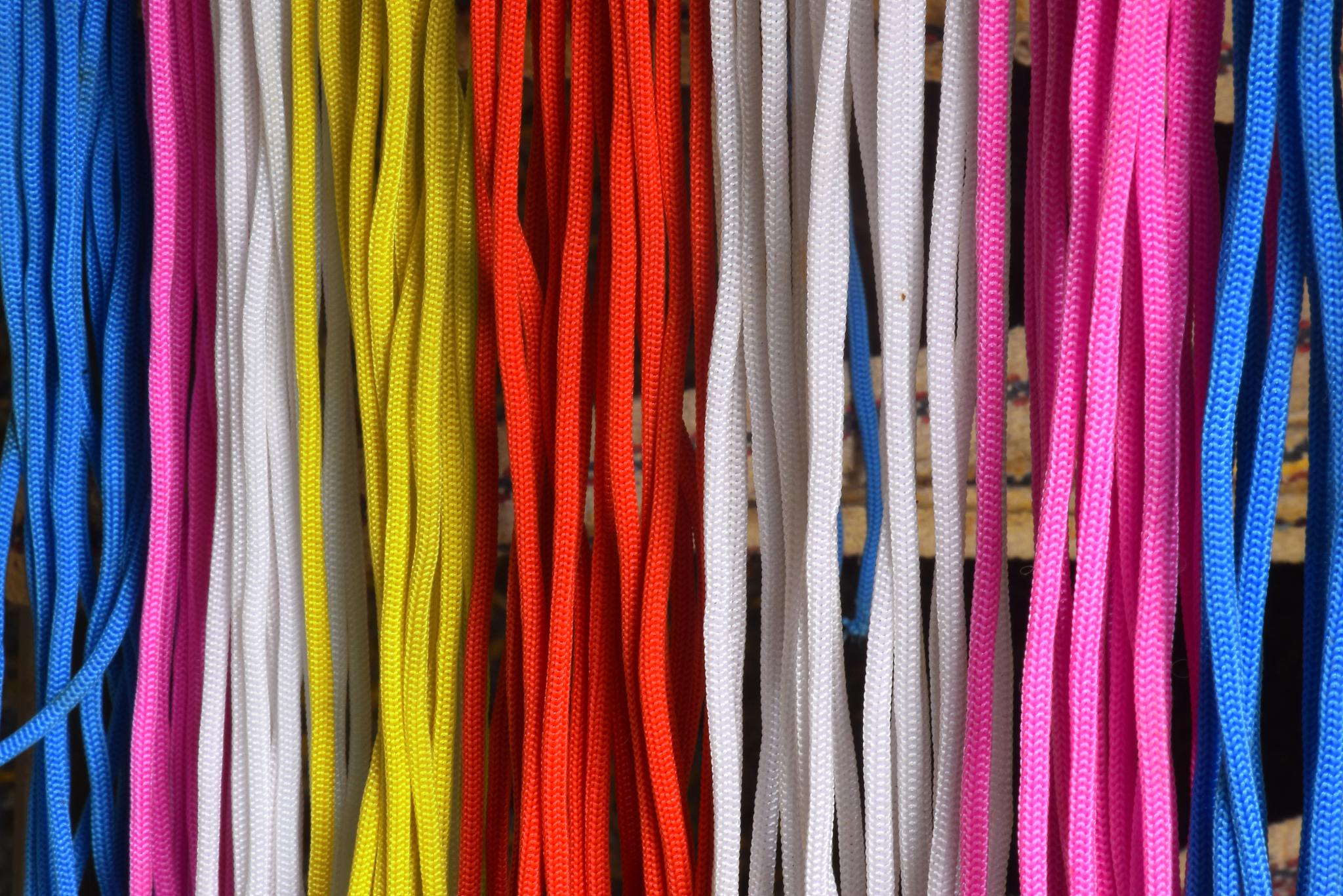 many multi colored threads of a wool for design background. text