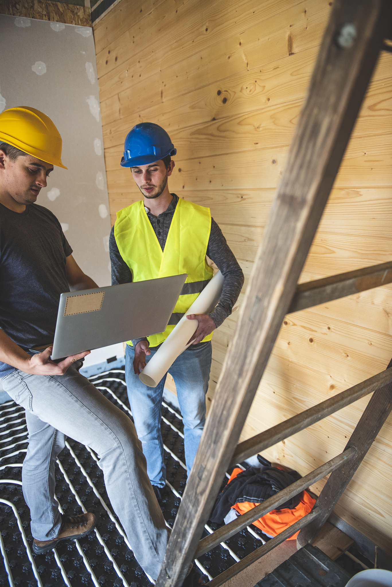 professional male engineer using laptop on construction site