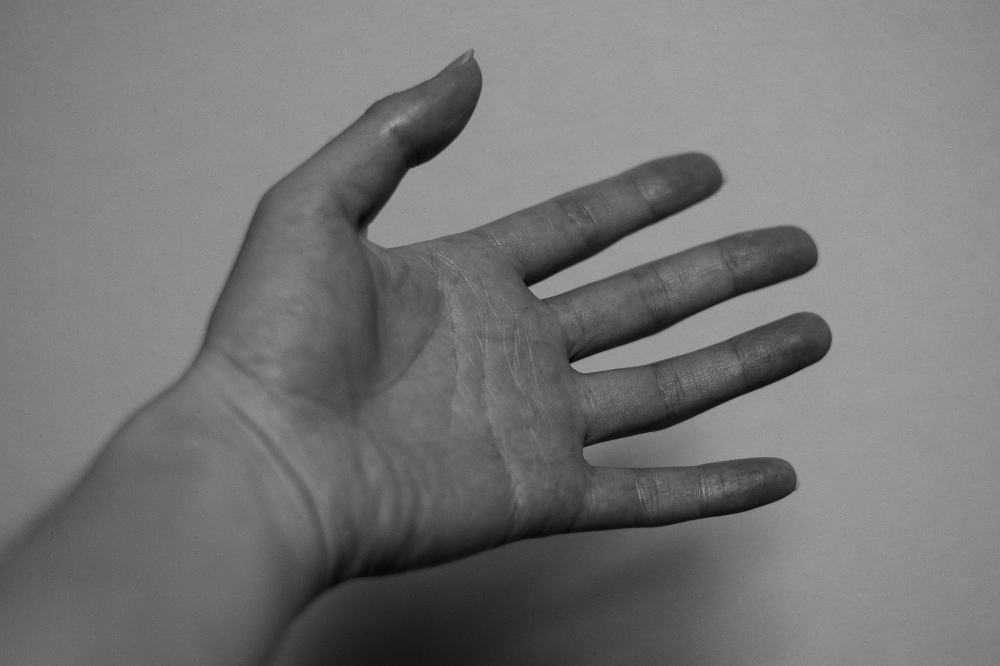close-up of human hand against wall