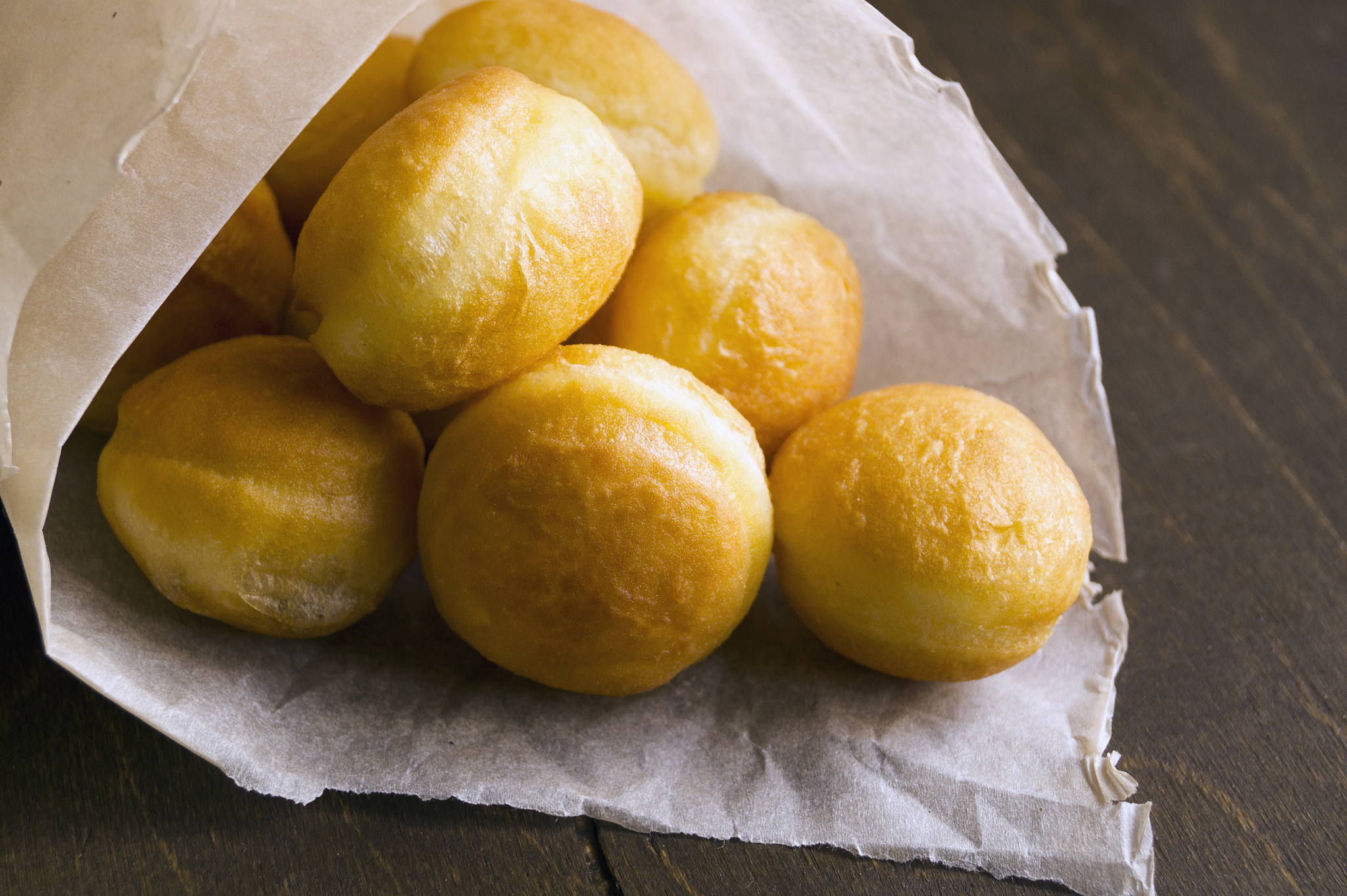 round donuts in a paper bag sprinkled with powder