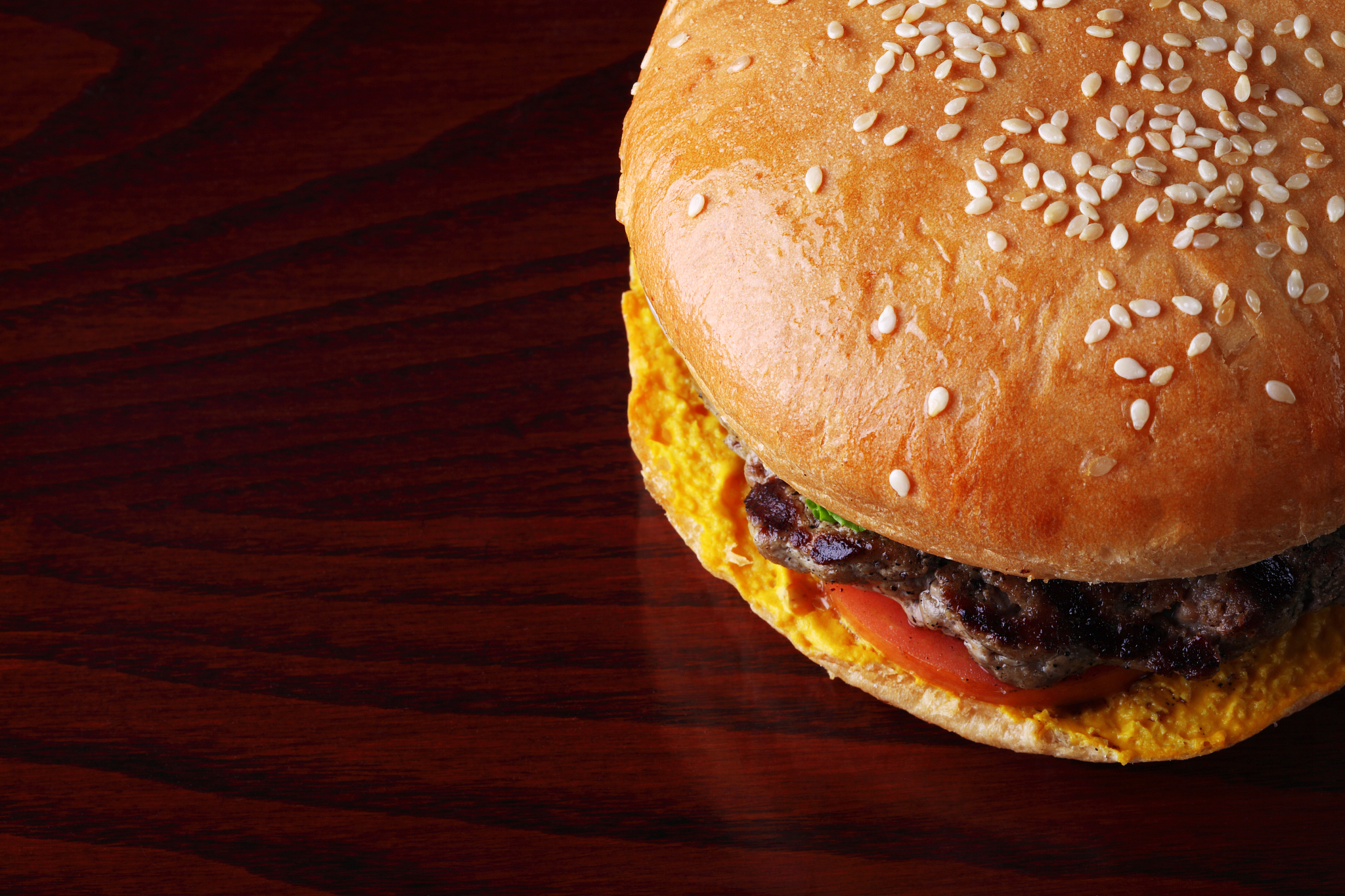 beef burger over wooden top