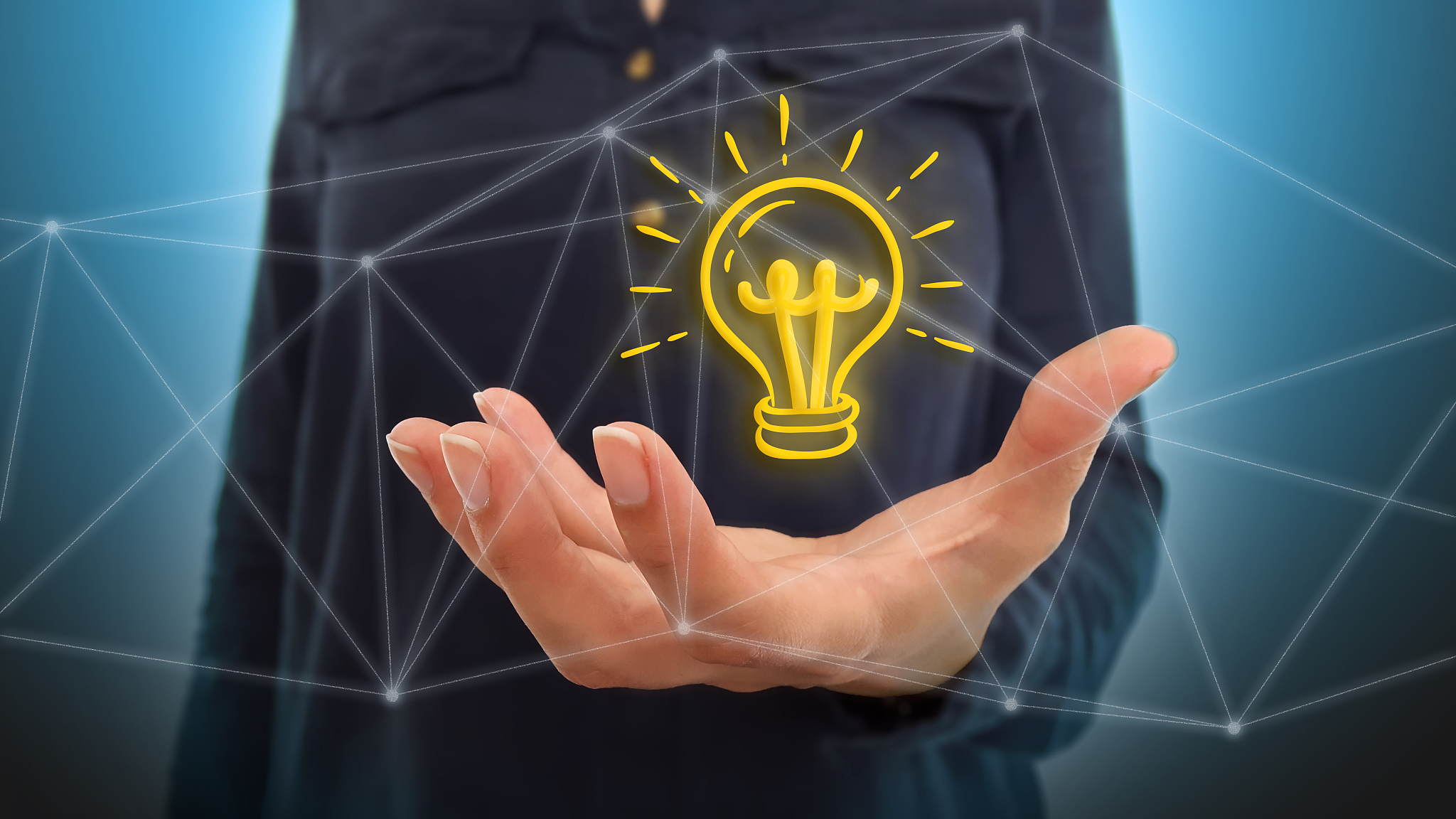 businesswoman on blurred background using light bulb over networ