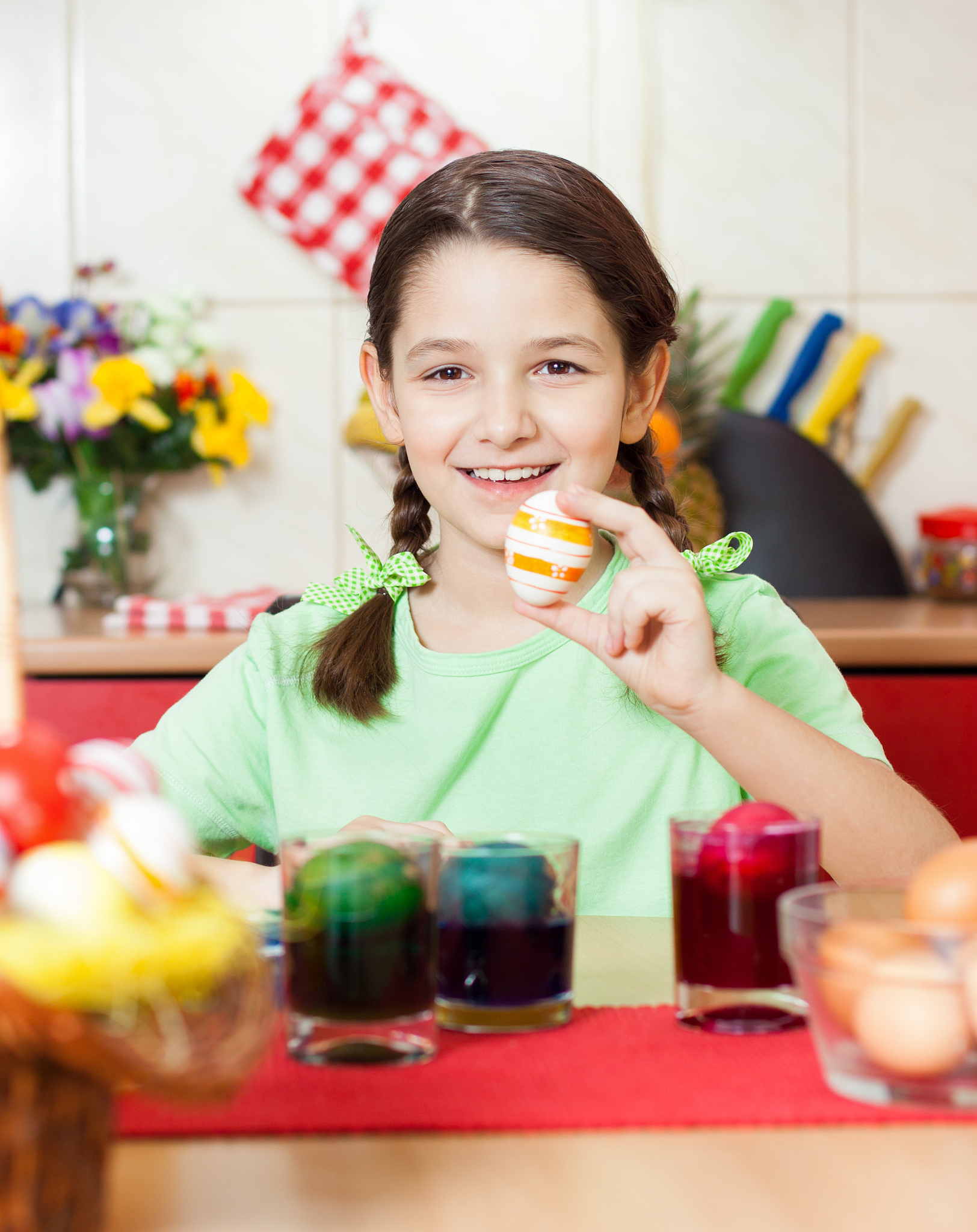 little girl painting easter eggs