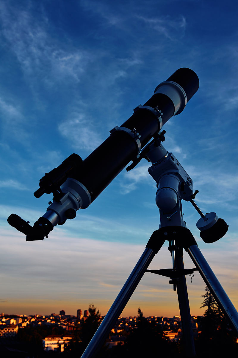 在黄昏的天空下,一个巨大的天文望远镜准备好观测星空.