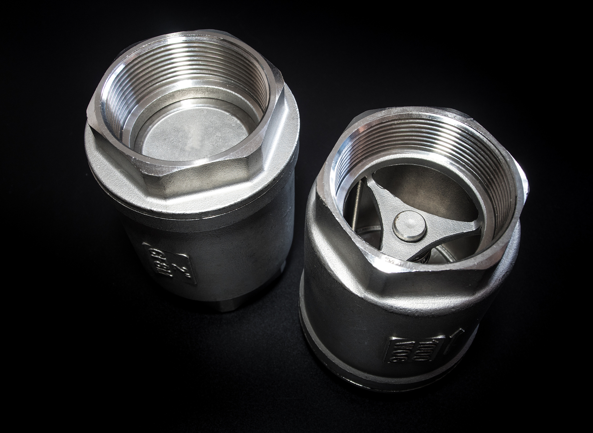 stainless steel check valve on black background