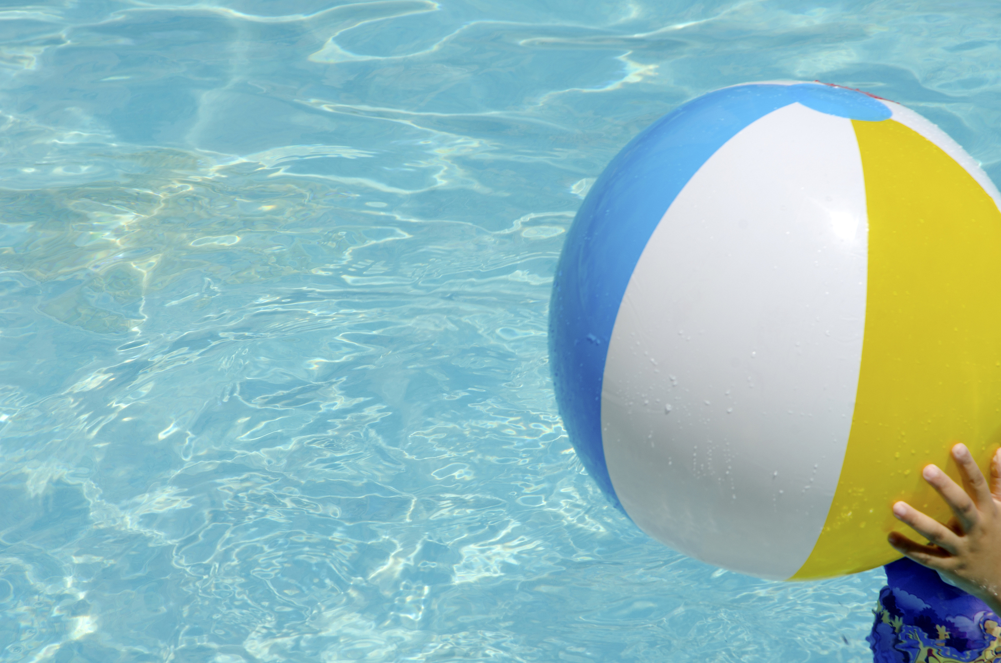 multicolored beach ball floating in a swimming pool